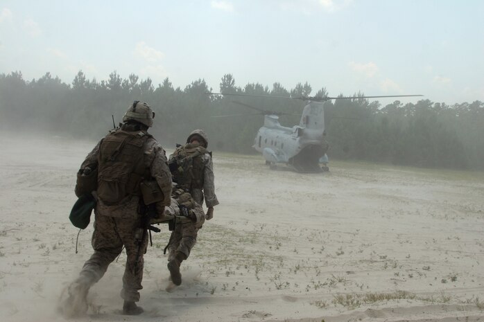 Petty Officer 2nd Class Cody T. West, a corpsman with Company A, 2nd Assault Amphibian Battalion,  and a Marine with Co. A, 2nd AA Bn., evacuate a casualty at landing zone Cardinal during the Mission Rehearsal Exercise, June 22. Special-purpose Marine Air-Ground Task Force Continuing Promise 2010 conducted a MRX from June 21-23 to demonstrate the level of unit readiness for the upcoming four-month deployment to Central and South American countries.