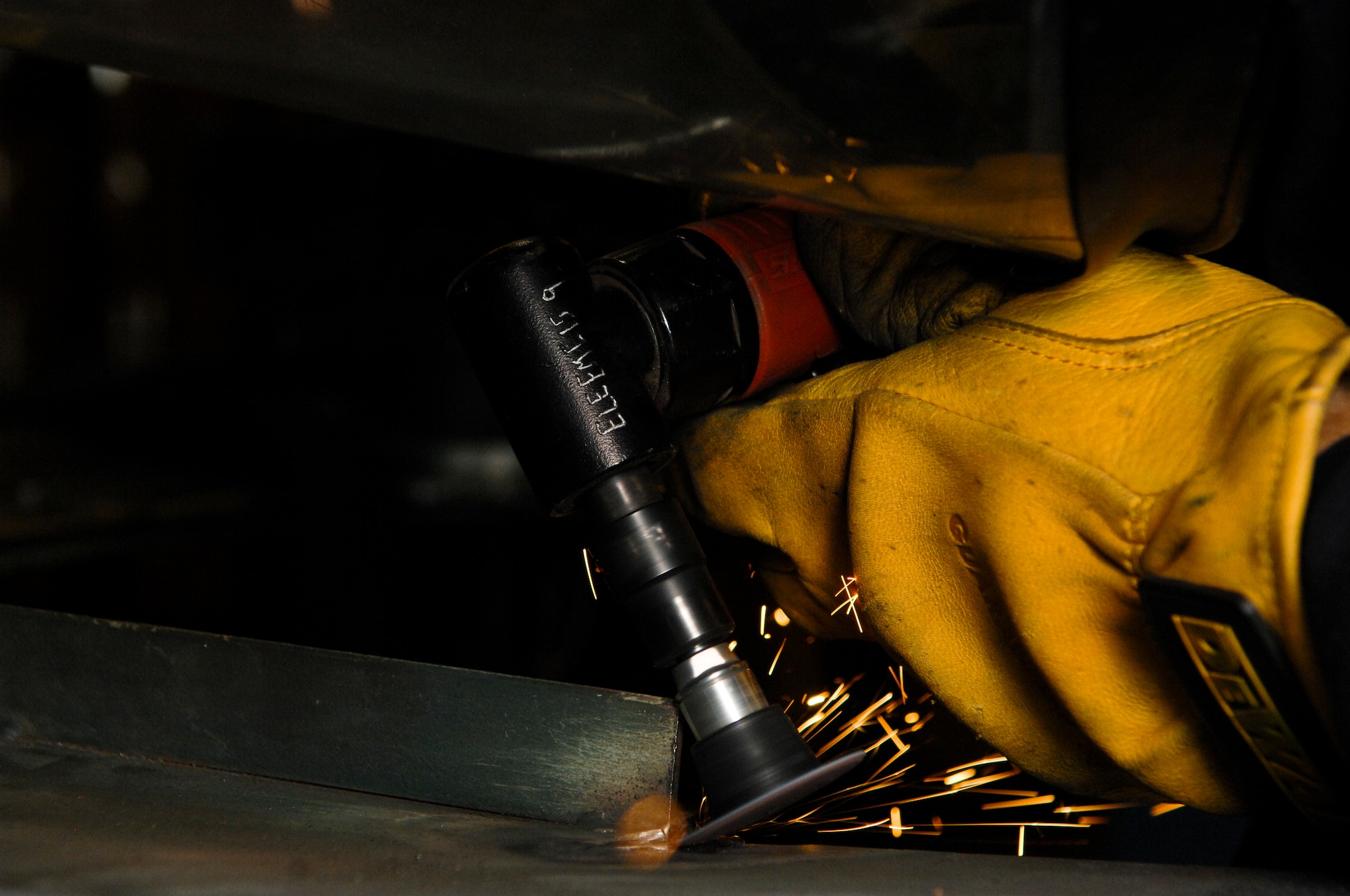 Airman 1st Class Derek Johnson, 3rd Equipment Maintenance Squadron, grinds down a weld on a piece of air-ground equipment, June 22. The metals technologies shop is responsible for many repair and maintenance jobs on Elmendorf. (Air Force photo by Airman 1st Class Jack Sanders)
