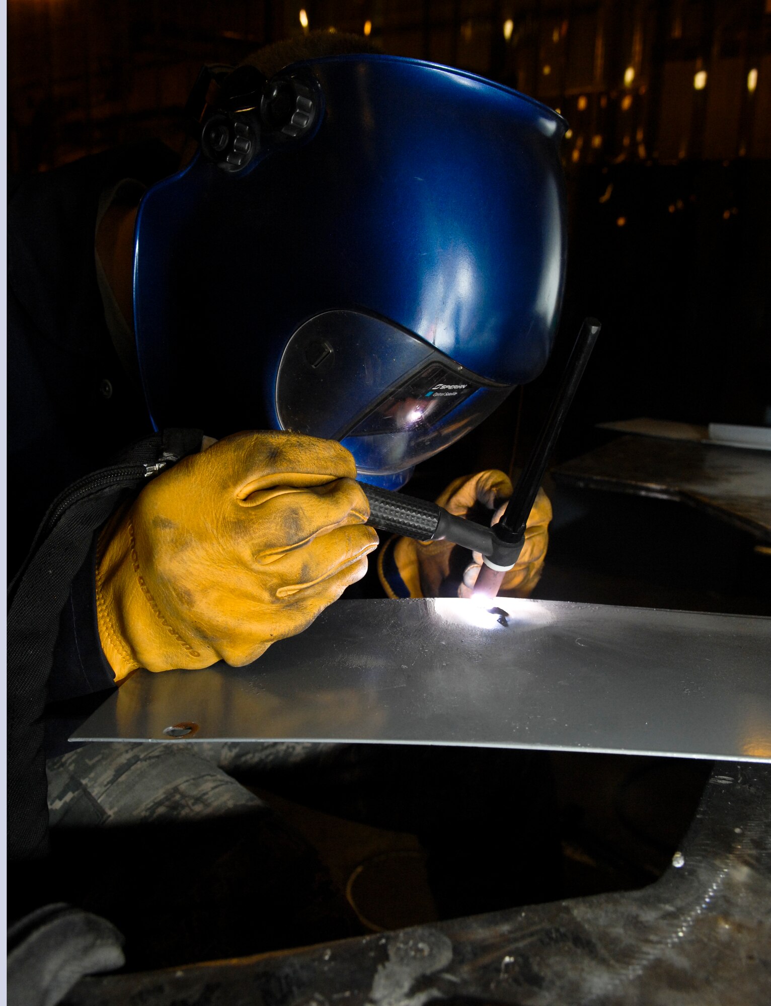 Airman 1st Class Derek Johnson, 3rd Equipment Maintenance Squadron welds repairs to air ground equipment, June 22. The metals technologies shop is responsible for many repair and maintenance jobs on Elmendorf. (Air Force photo by Airman 1st Class Jack Sanders)