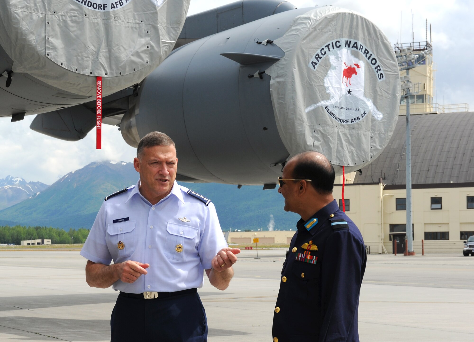 Gen. Gary North, Pacific Air Forces commander, talks with Air Commodore M. Sanaul Huq, Air Officer Commanding, Bangladesh Air Base Zahurul Haque, on the flightline at Joint Base Elmendorf-Richardson, Alaska, during the 2010 Executive Observer Program June 18. PACAF leaders hosted general officers from 16 different countries during PACAF's premier multinational large-force employment exercise with the goal of building partnerships with senior air-power leaders from the global community." (Air Force photo/SrA Cynthia Spalding)