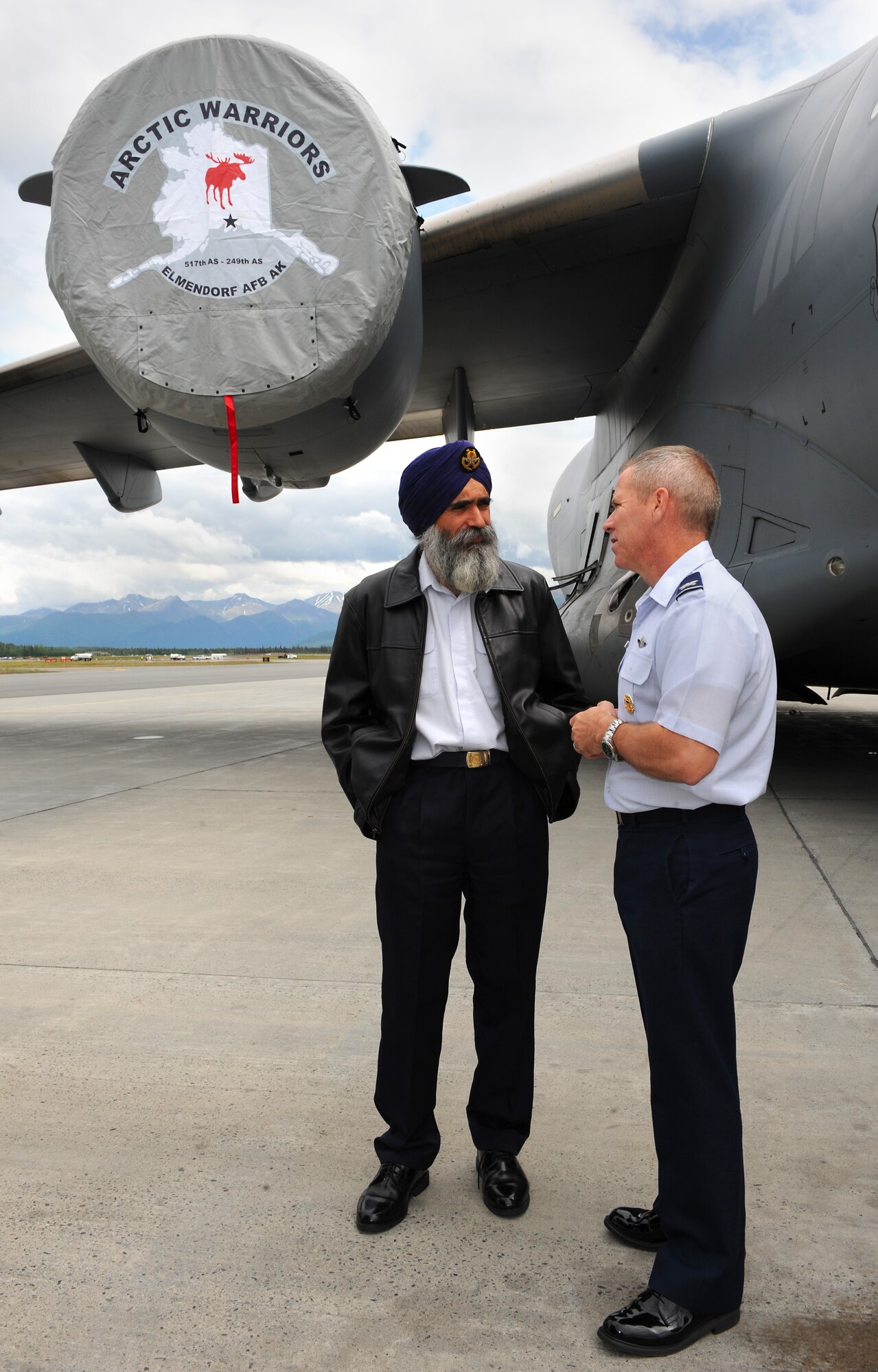 JOINT BASE ELMENDORF-RICHARDSON, Alaska -- Col. John McMullen, 3rd Wing commander, talks with Col. Sarbjit Singh, Air Power Generation Command commander, Singapore, on the flightline during the 2010 Executive Observer Program June 18. During the program, observers were presented an overview of Red Flag-Alaska and a flightline tour. (Air Force photo by Senior Airman Cynthia Spalding)
