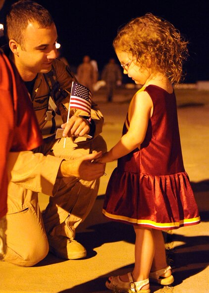 DYESS AIR FORCE BASE, Texas—Capt. Nick Redenius, 39th Airlift Squadron, shares a moment with his daughter Annabelle here June 23 after returning from a six-month deployment supporting Overseas Contingencies Operations. Over 180 Airmen from the 317th Airlift Group, 7th Component Maintenance Squadron and 7th Logistics Readiness Squadron were greeted by family members, co-workers and friends. (U.S. Air Force photo/ Airman 1st Class Brittney Smolinski)