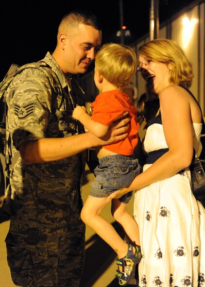 DYESS AIR FORCE BASE, Texas—Staff Sgt. Sean Desrochers, 39th Airlift Squadron, reaches out to hold his son here June 23 after returning from a six-month deployment supporting Overseas Contingencies Operations. Over 180 Airmen from the 317th Airlift Group, 7th Component Maintenance Squadron and 7th Logistics Readiness Squadron were greeted by family members, co-workers and friends. (U.S. Air Force photo/ Airman 1st Class Brittney Smolinski)