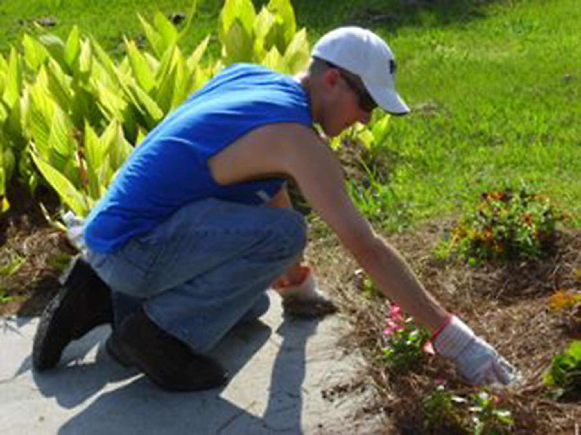Senior Airman Adam McCullough tends to a flower bed June 19, 2010, at Windwood Farm in Awendaw, S.C. Airman McCullough joined Airmen from Joint Base Charleston in volunteering at the farm to improve the lives of the children who live there. Airman McCullough is with the 181st Logistics Readiness Squadron, Hulman Field, Ind. (Courtesy photo)