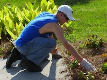 Senior Airman Adam McCullough tends to a flower bed June 19, 2010, at Windwood Farm in Awendaw, S.C. Airman McCullough joined Airmen from Joint Base Charleston in volunteering at the farm to improve the lives of the children who live there. Airman McCullough is with the 181st Logistics Readiness Squadron, Hulman Field, Ind. (Courtesy photo)