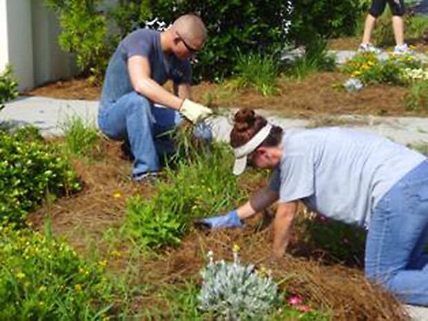 Airman 1st Class Humphrey Tanner and Tech. Sgt. Jennifer King volunteer at Windwood Farm in Awendaw, S.C., June 19, 2010. Windwood Farm is a private 501(c)3 not for profit organization which is licensed by South Carolina Department of Social Services to provide intensive care, residential group home services to boys ages 5 to 16. The Airmen volunteered with Airmen Against Drunk Driving to provide better living conditions for the children who live at the farm. Airman Tanner is with the 16th Airlift Squadron, and Sergeant King is with the 628th Security Forces Squadron. (Courtesy photo)