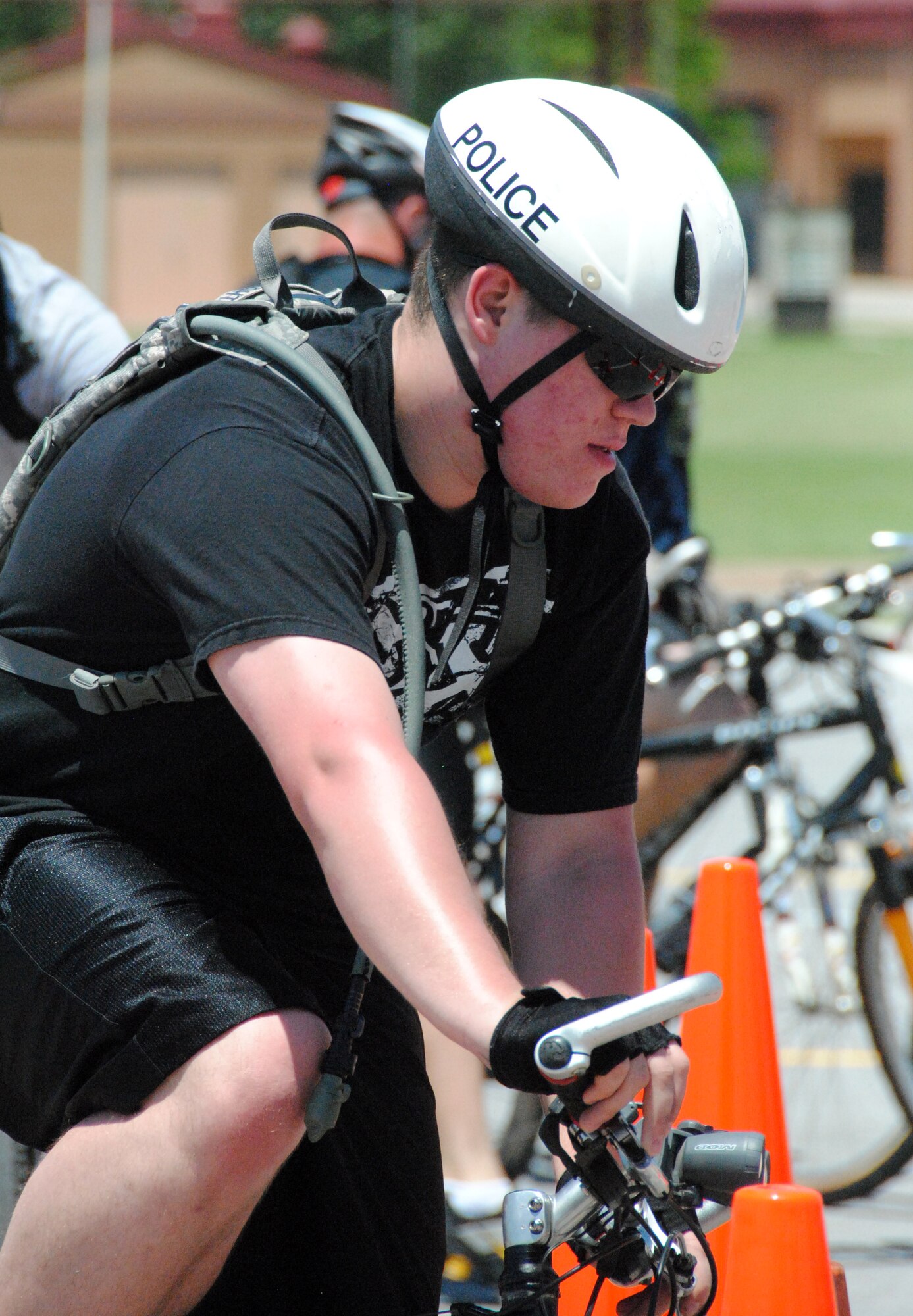 Airman 1st Class Steven Armbright, with the 71st Security Forces Squadron here, concentrates on maneuvering his bicycle through the orange cones, part of a tactical skills course taught by instructors from Luke AFB, Ariz. (U.S. Air Force photo/ Joe B. Wiles)