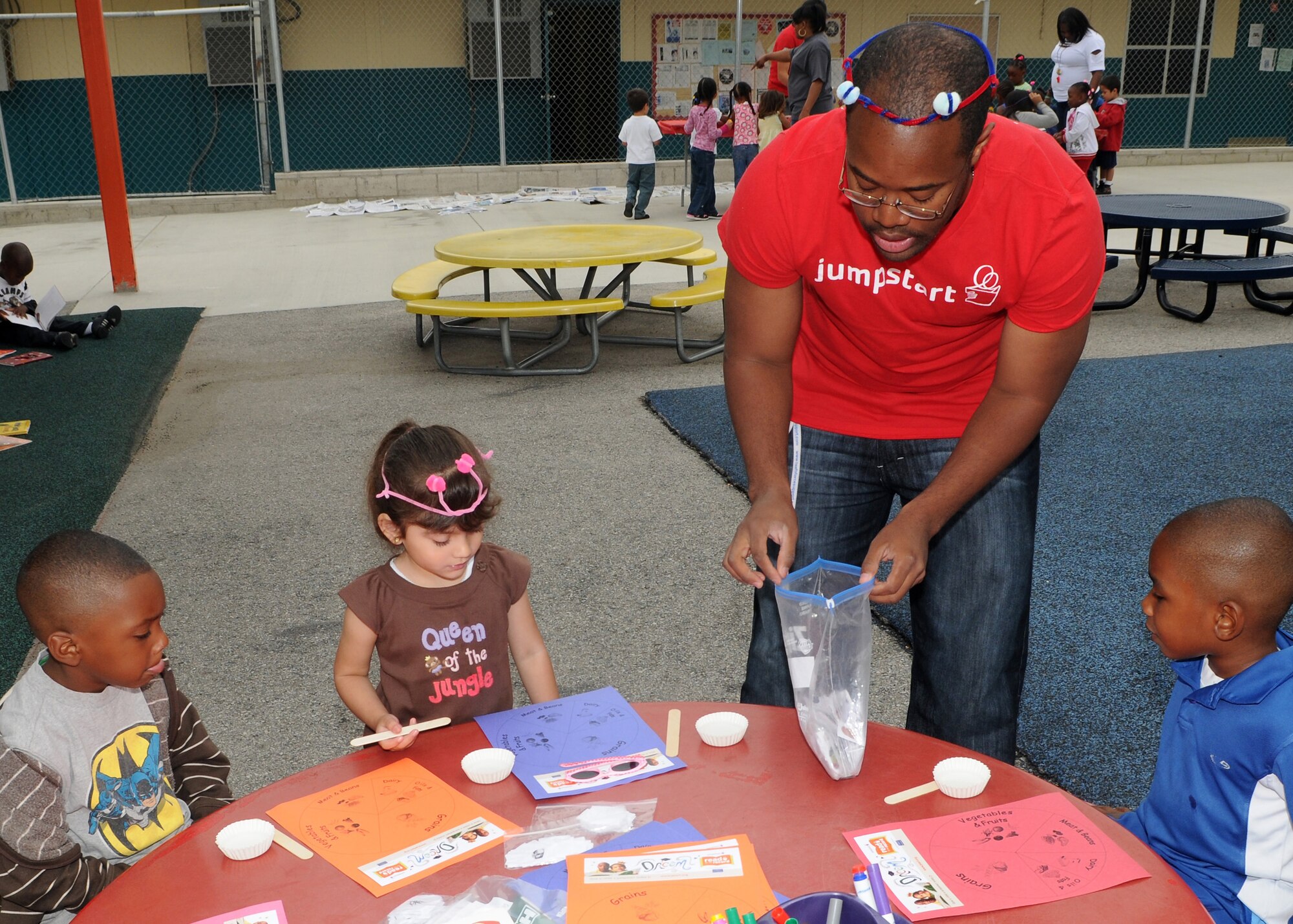 Children at the Inglewood Child Development Center work on arts and craft projects with the help from a volunteer from the 61st Communications Squadron, June 22. .  The center is run by the Inglewood Unified School District and provides programs for preschoolers, ages 3 to 5. (Photo by Jim Gordon) 