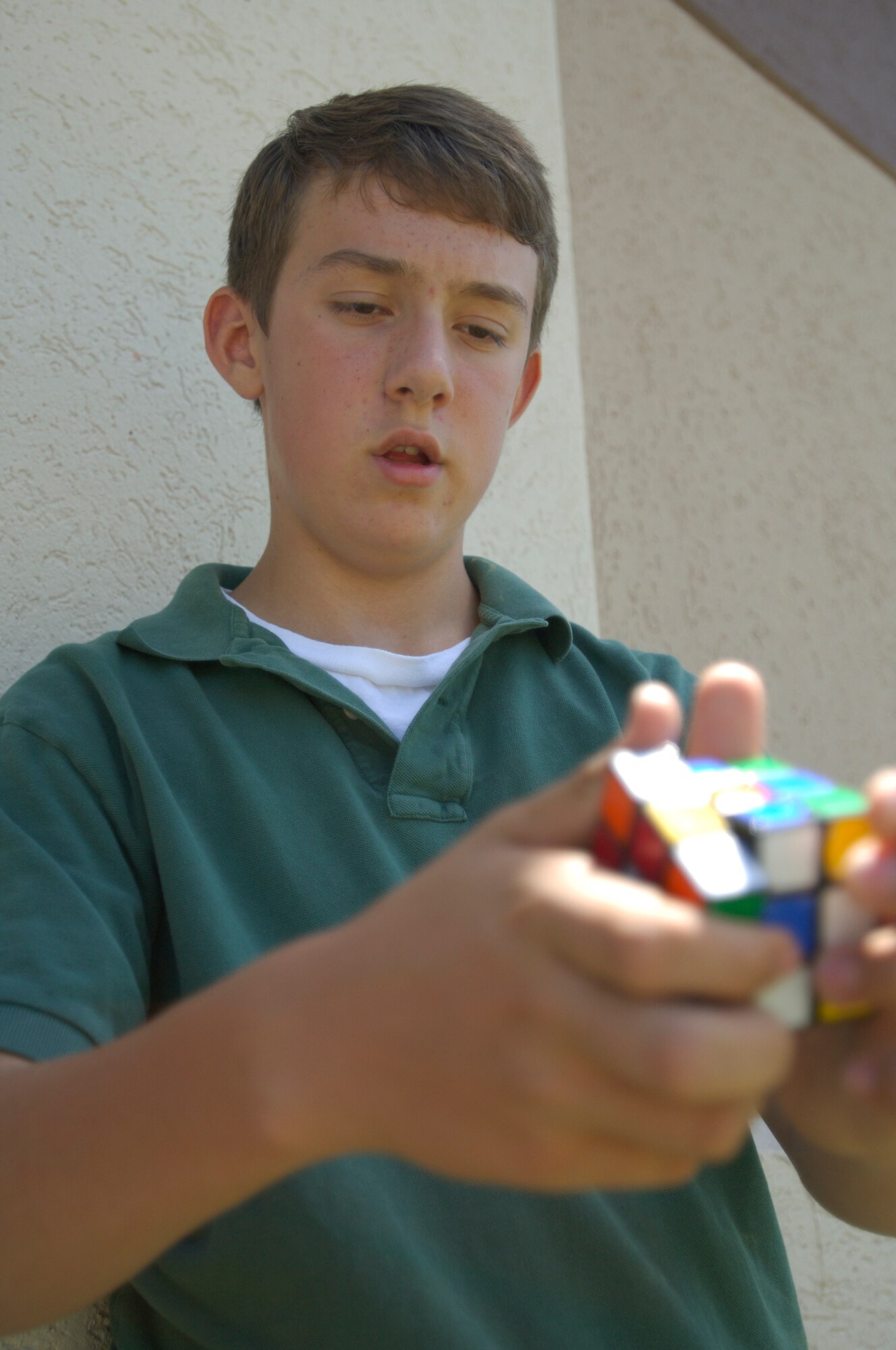 Matthew Doyle Lee, son of Elizabeth Lee, 22nd Force Support Squadron coordinator of family services, and Senior Master Sgt. John Lee, 22nd Operations Support Squadron tower chief controller, solves his Rubik’s Cube June 18, 2010, McConnell Air Force Base, Kan. Matthew received the Bernard Curtis Brown II Memorial NASA Space Camp Scholarship from the Military Child Education Coalition. (U.S. Air Force photo/Airman Armando A. Schwier-Morales.)