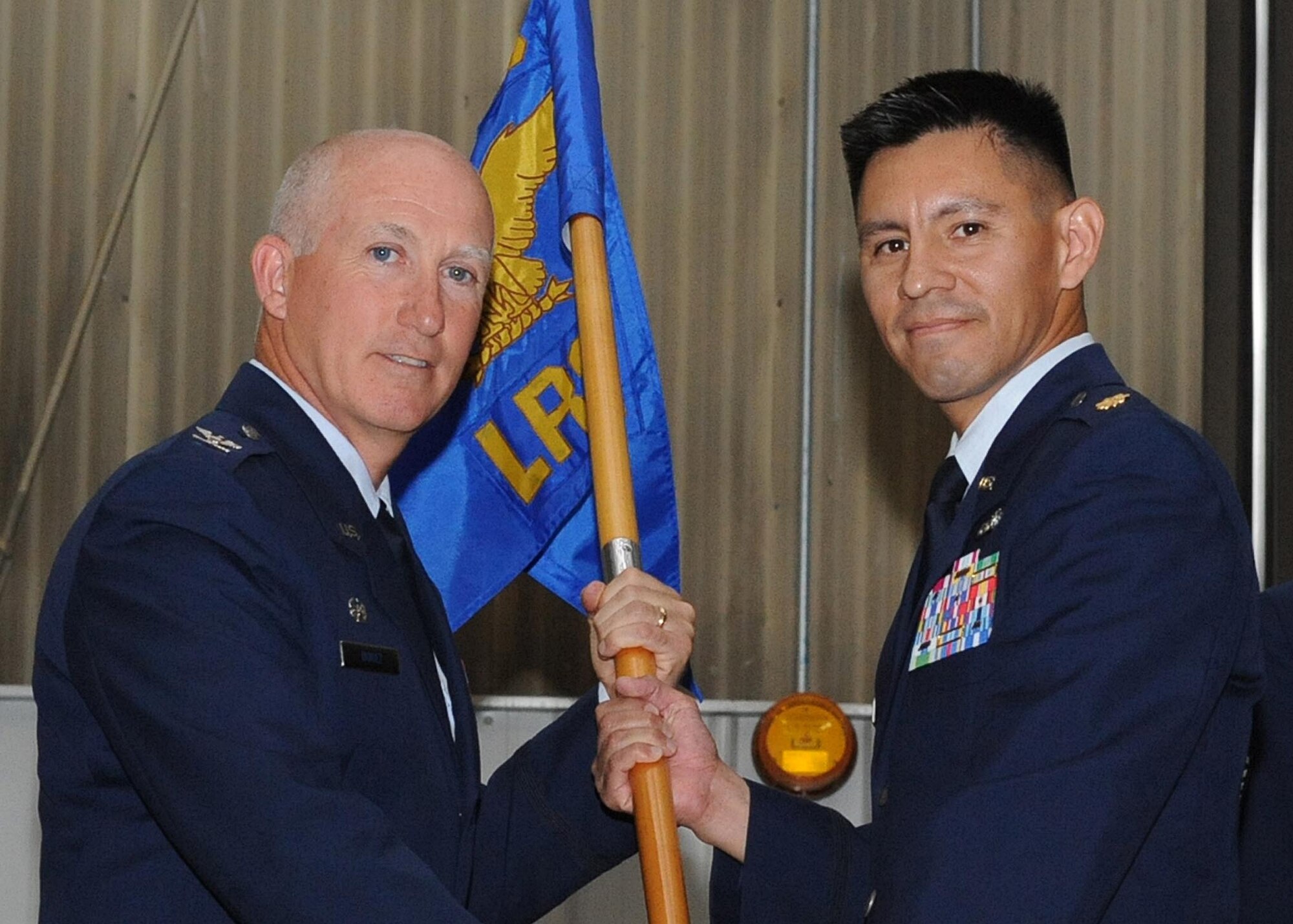 Major Reynaldo Gonzales Jr., (right) assumes command of the 319th Logistics Readiness Squadron from Col. Joseph Douez, 319th Mission Support Group commander, during a change-of-command ceremony, June 23 at Grand Forks Air Force Base, North Dakota. Major Gonzales assumed command of the 319 LRS from Major Robert A. Kielty. (U.S. Air Force photo by Airman 1st Class Amber Price)
