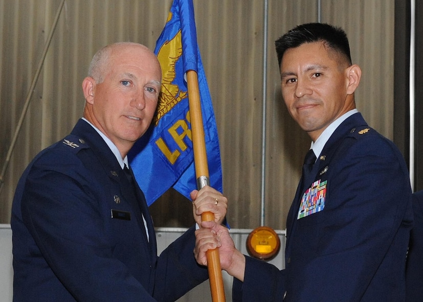 Major Reynaldo Gonzales Jr., (right) assumes command of the 319th Logistics Readiness Squadron from Col. Joseph Douez, 319th Mission Support Group commander, during a change-of-command ceremony, June 23 at Grand Forks Air Force Base, North Dakota. Major Gonzales assumed command of the 319 LRS from Major Robert A. Kielty. (U.S. Air Force photo by Airman 1st Class Amber Price)