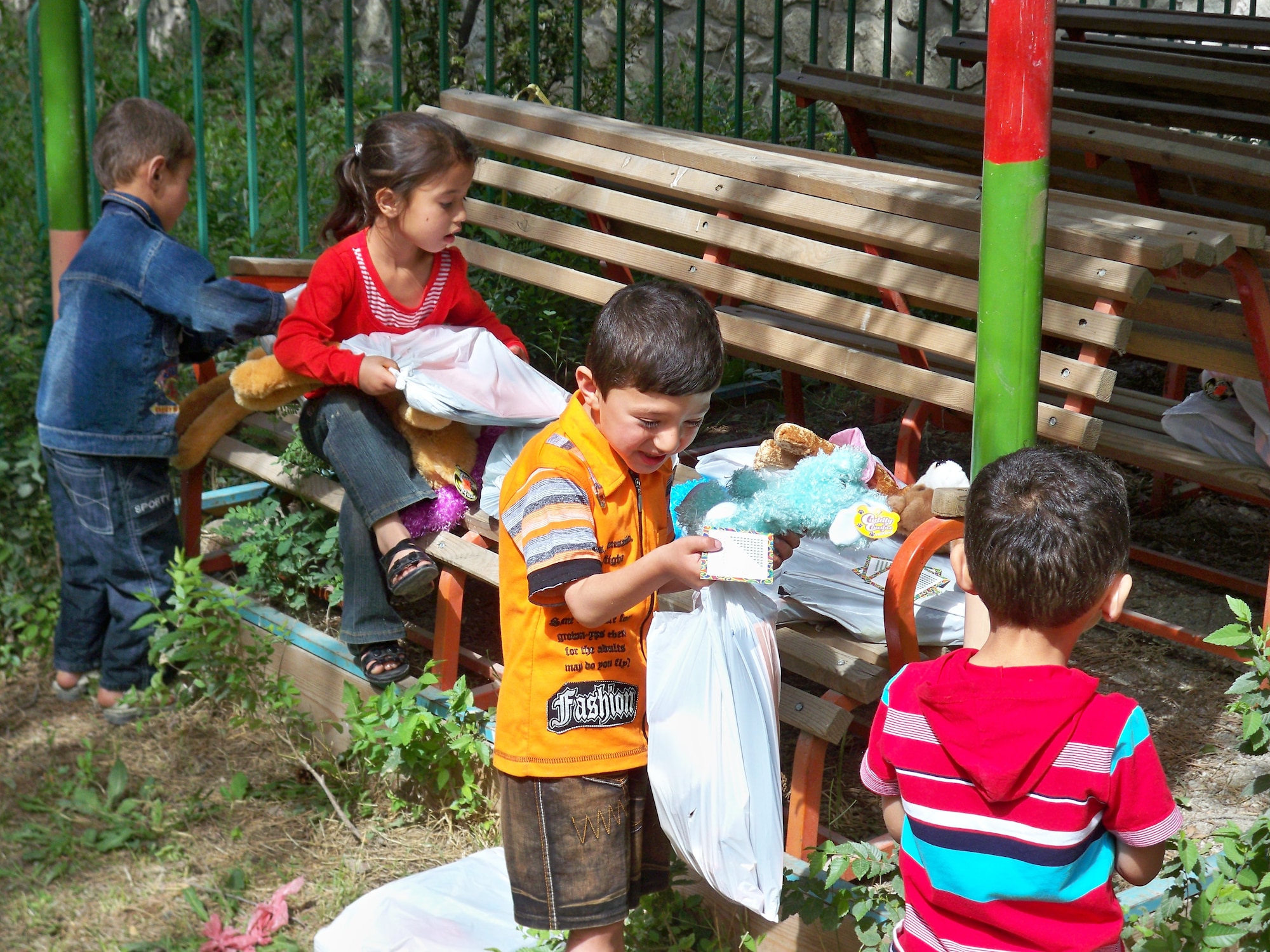 SOUTHWEST ASIA -- Afghan orphans unpack care packages sent to them by members of Team Buckley. (U.S. Air Force photo)