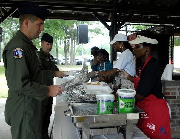 Members of Joint Team Charleston line up to be served lunch at the third annual Juneteenth Fish Fry on Joint Base Charleston, S.C., June 17, 2010. The event was hosted by the African American Heritage Council and all proceeds from the event are put toward scholarships and school supplies for local area schools. The council awards three scholarships to high school students ranging from $250 to $500. (U.S. Air Force Photo/Airman 1st Class Lauren Main)