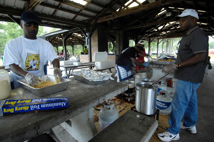 Members of Joint Team Charleston help fry fish for the third annual Juneteenth Fish Fry at the base picnic grounds on Joint Base Charleston, S.C., June 17, 2010. Army Maj. Gen. Gordon Granger traveled to Glaveston, Texas, 145 years ago and issued the proclamation that all those still enslaved were free. The fish fry hosted annually by the African American Heritage Council commemorates this historical event. (U.S. Air Force Photo/Airman 1st Class Lauren Main)