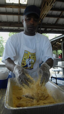 Senior Master Sgt. Terry Jones breads fish to be fried at the third annual Juneteenth Fish Fry on Joint Base Charleston, S.C., June 17, 2010. The event was hosted by the African American Heritage Council and all proceeds from the event are put toward scholarships and school supplies for local area schools. Sergeant Jones is the superintendent of aviation management with the 437th Operations Support Squadron. (U.S. Air Force Photo/Airman 1st Class Lauren Main)