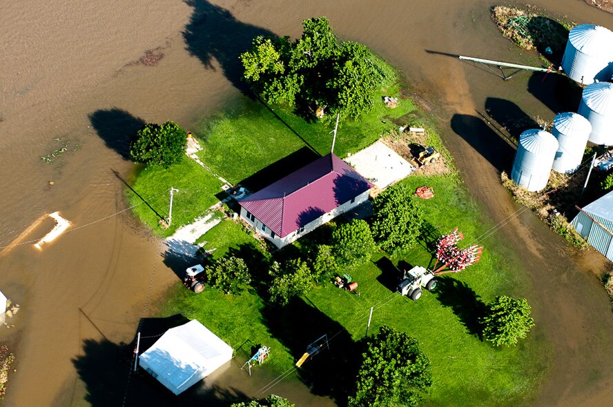 A house stands defiant as the surrounding country side is engulfed by flood water in Northern Missouri on June 22, 2010, after weeks of heavy rains and massive storms. Mo. Governor Jay Nixon declared a state of emergency on June 21, 2010 and has been traveling north to survey the effected towns and provide assistance where needed. (U.S. Air Force photo by Master Sgt. Shannon Bond/Released)
