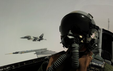 U.S. Air Force Tech. Sgt. James Harper Jr. takes a self-portrait along alongside an F-16 Aggressor aircraft from the 18th Aggressor Squadron out of Eielson Air Force Base, Alaska, during a sortie at Eielson June 15, 2010, in support of training exercise Red Flag-Alaska 10-3. Sergeant Harper captures aerial photography as part of his career as a combat cameraman. He is assigned to the 1st Combat Camera Squadron. (U.S. Air Force photo by Technical Sgt. James Harper Jr./Released)