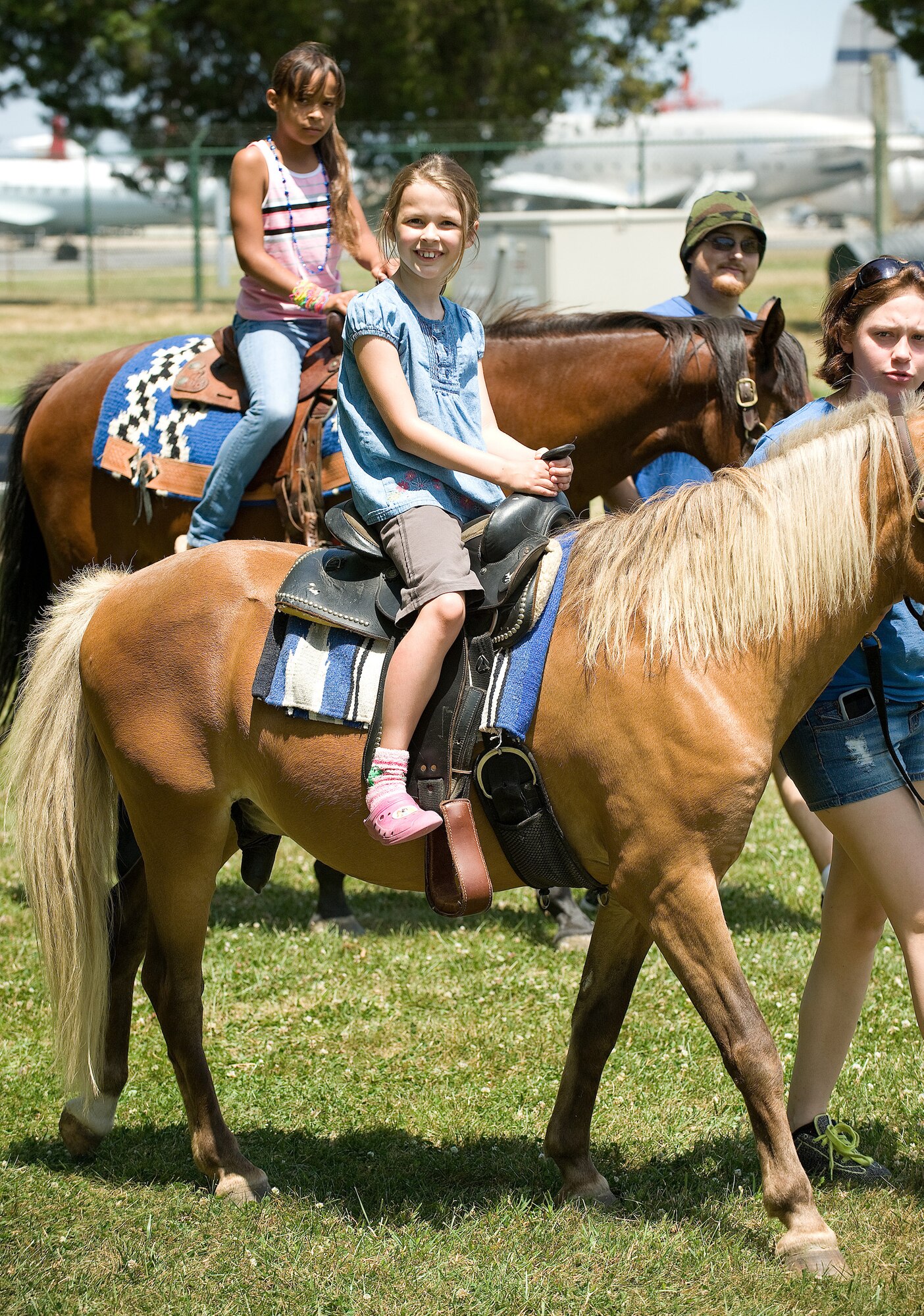Children enjoyed a pony ride at the Dover Air Force Base Wing Picnic June 18.  Pony rides were just some of the multitude of events going on at the picnic.  There were moon bounces, prize drawings and a live band as well.  (U.S. Air Force photo by Jason Minto/Released)