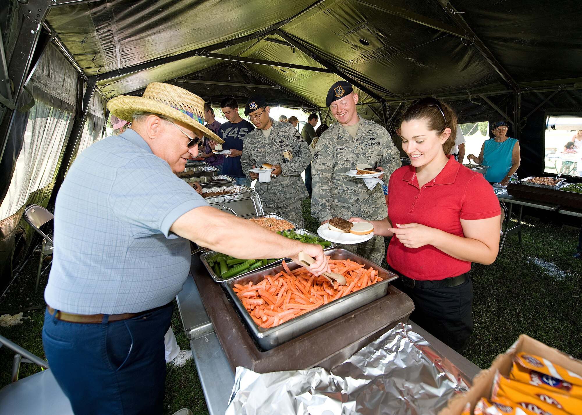 Team Dover members get food during the Dover Air Force Base Wing Picnic June 18.  The picnic featured a live band and other entertainment such as a prize drawing and booths for different wing associations and local businesses.  (U.S. Air force photo by Jason Minto/Released)
