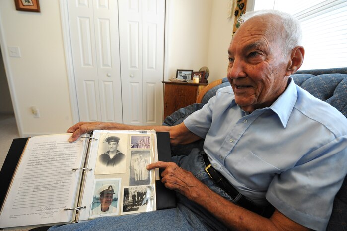 Reid Cayce shares World War II stories and scrapbook photos at his home in Summerville, S.C., June 15, 2010. Mr. Cayce, a Navy veteran, enlisted Jan. 15, 1943. He participated in the invasion of Normandy June 6, 1944, and was honorably discharged Jan. 31, 1946, with three years and 16 days of service in the Navy. (U.S. Air Force photo/James M. Bowman)