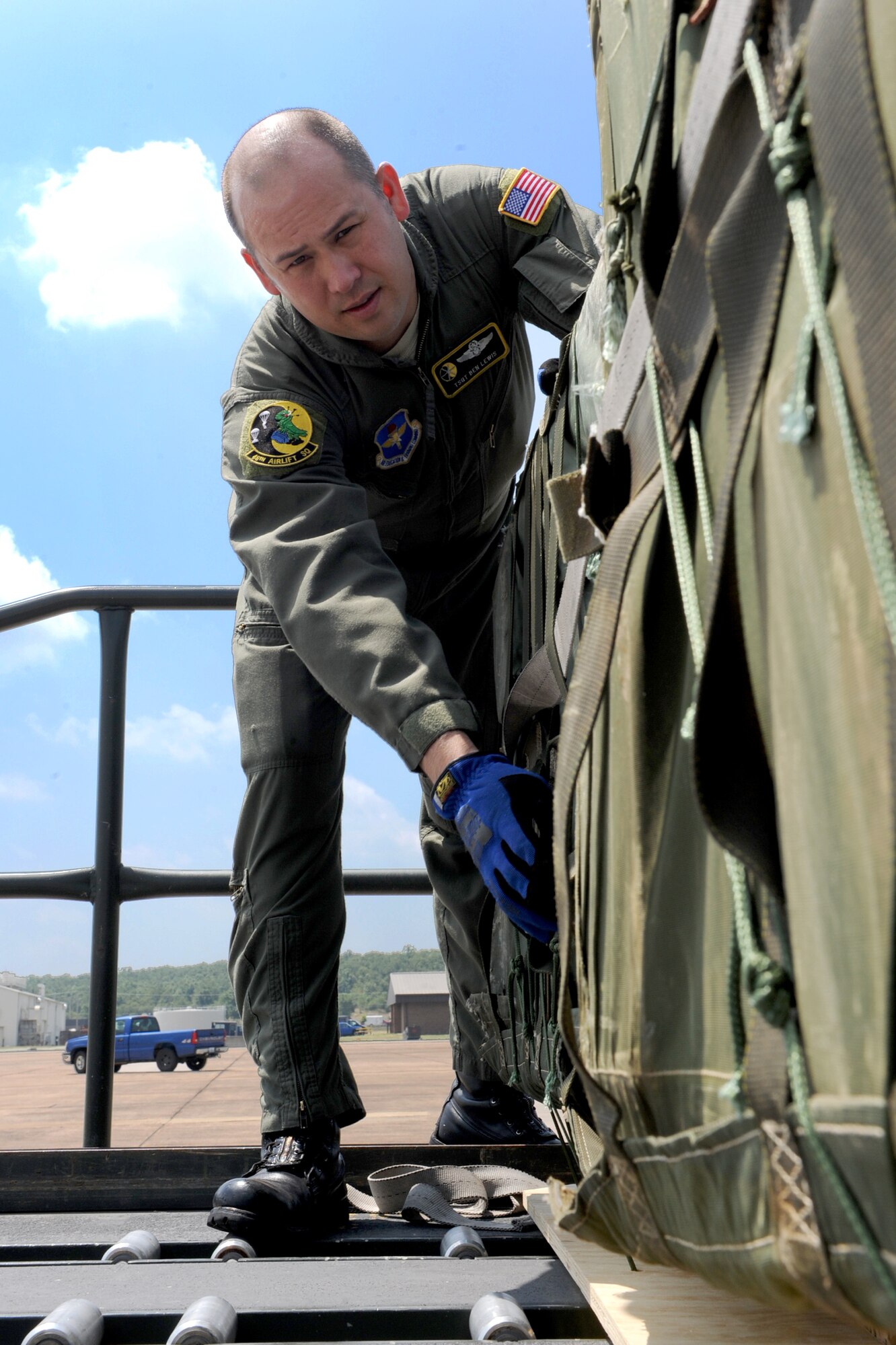 Tech. Sgt. Benjamin Lewis, 48th Airlift Squadron instructor loadmaster, inspects a container delivery system to make sure it’s rigged properly to prevent any malfunctions during an airdrop. Sergeant Lewis streamlined squadron ground safety training records; with 19th Air Force staff assistance visit validated total compliance for the Air Force personnel safety program. (U.S. Air Force photo by Senior Airman Ethan Morgan)