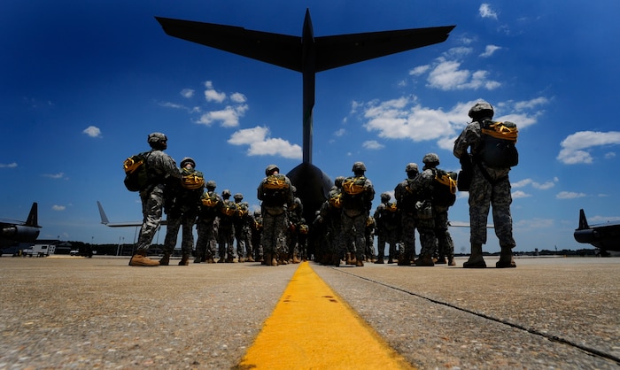 The tail of a Charleston C-17 fills the sky as U.S. Soldiers wait to board on the flightline at Pope Air Force Base, N.C., during a joint forcible entry exercise June 21, 2010. More than 98 service members performed an airborne insertion from the C-17 during the JFEX. JFEX, which is a week-long exercise conducted six times a year by Soldiers from Fort Bragg and Airmen from Pope AFB and Joint Base Charleston, is designed to enhance cohesion between the Army and Air Force through large-scale heavy equipment and troop movements. (U.S. Air Force photo by Staff Sgt. Angelita M. Lawrence/Released)