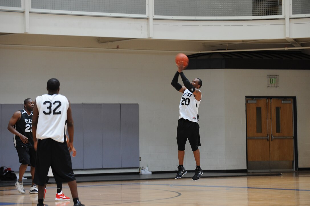 DYESS AIR FORCE BASE, Texas—Kelvin Thompson shoots a basketball during a tournament at the Dyess Fitness Center June 19 here. The Dyess men’s basketball team hosted the event to raise money to help them participate in basketball tournaments. The tournament started Friday night and picked back up Saturday morning with five teams competing both days. (U.S Air Force photo/ Airman 1st Class Shannon Hall)