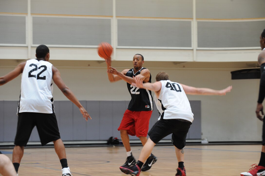 DYESS AIR FORCE BASE, Texas—Senior Airman Billy Pryor, 317th Maintenance Squadron, passes a basketball while playing in a tournament at the Dyess Fitness Center June 19 here. The Dyess men’s basketball team hosted the event to raise money to help them participate in basketball tournaments. The tournament started Friday night and picked back up Saturday morning with five teams competing both days. (U.S Air Force photo/ Airman 1st Class Shannon Hall)