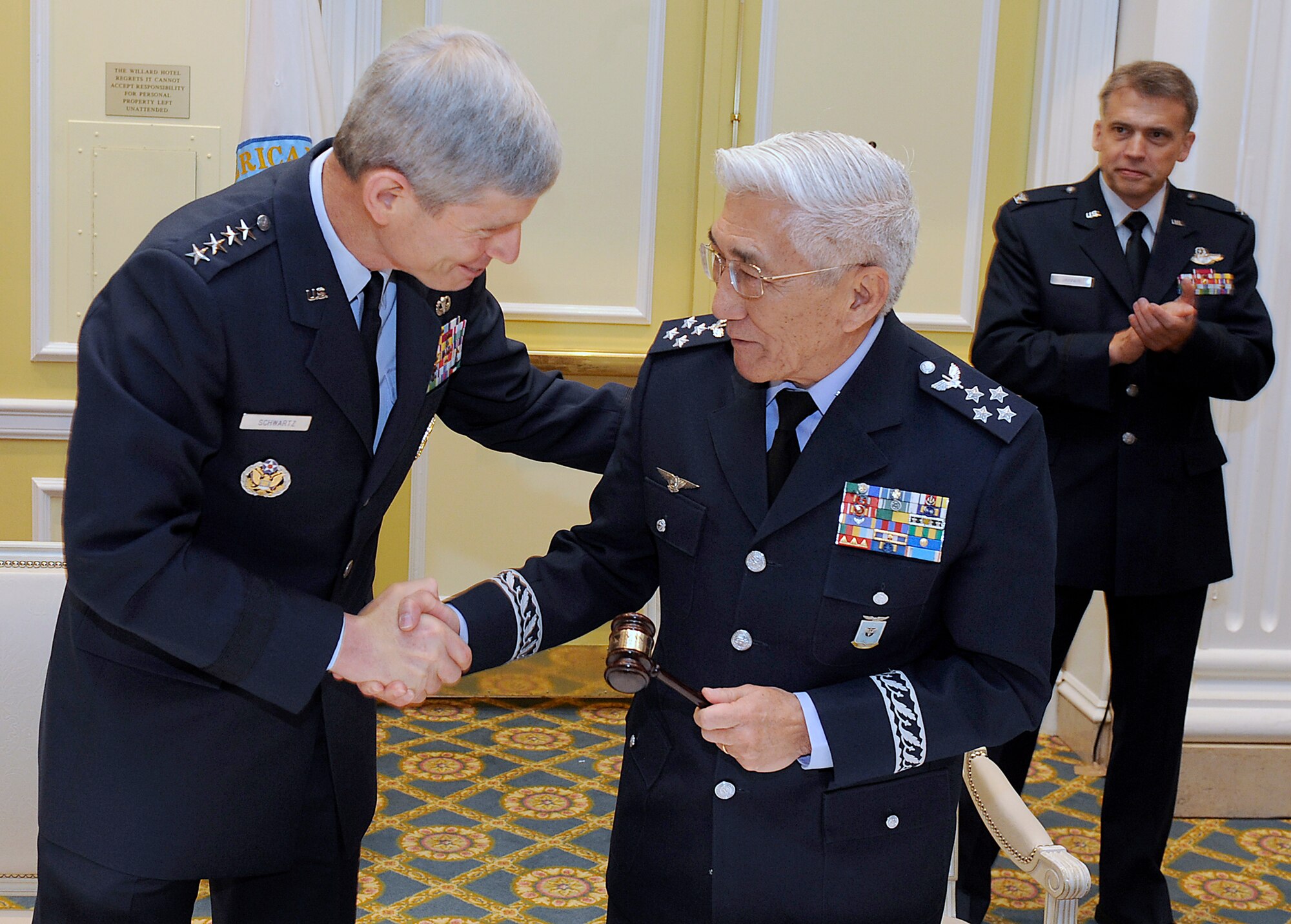 U.S. Air Force Chief of Staff Gen. Norton Schwartz passes a gavel and congratulates Air Lt. Gen. Juniti Saito, the aeronautical commander of the Brazilian air force, during "Conference of Chiefs of American Air Forces" (CONJEFAMER) June 16,2010, in Washington, D.C. The passing of this gavel to General Saito demonstrates that he will be the president and host of CONJEFAMER 2011 in Brazil. (U.S. Air Force photo/Scott M. Ash)