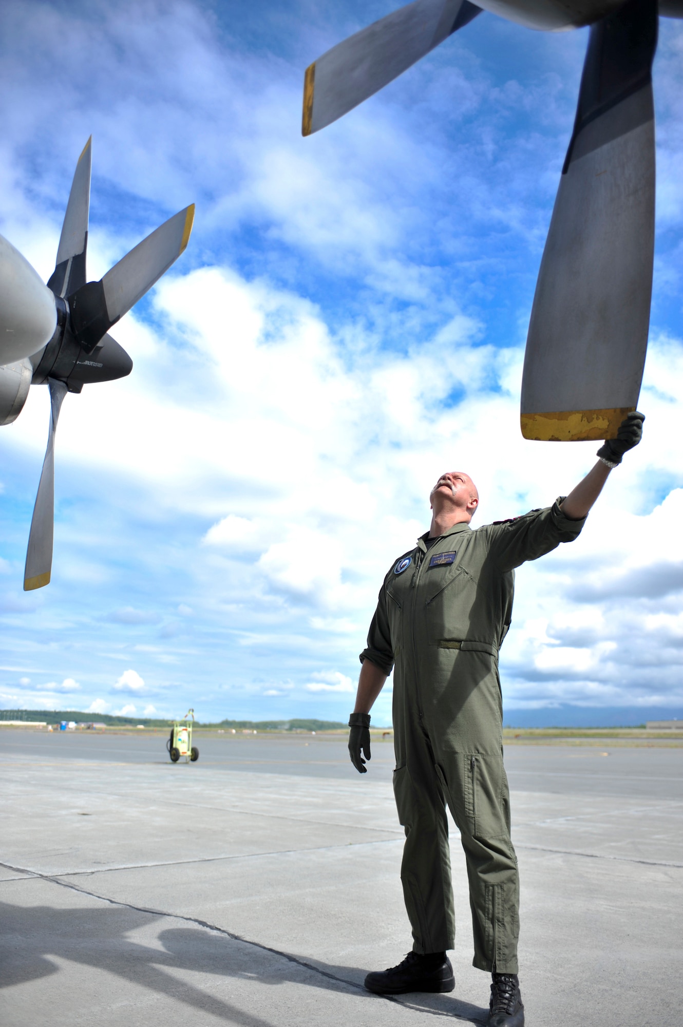JOINT BASE ELMENDORF-RICHARDSON, Alaska – Adjudant Christlaen Yues, Belgian Air Component 15th Air Transport Wing 20th Squadron flight engineer, performs a pre-flight inspection on a Belgian C-130 Hercules June 22. This was the first time the BAC has participated in RF-Alaska. (Air Force photo by Airman 1st Class Christopher Gross)