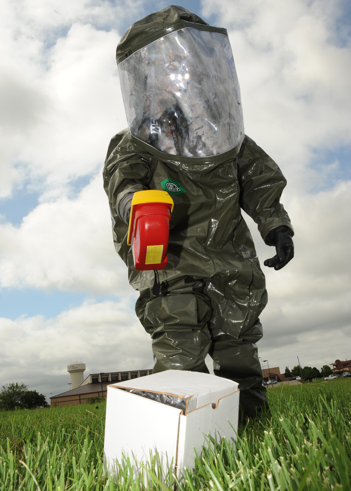 Staff Sgt. Cody LeNeve, 22nd Aerospace Medicine Squadron bioenvironmental engineering apprentice, wears a level A suit while he tests the x-ray and gamma radiation detection machine on a sample outside of the base clinic June 15, 2010, McConnell Air Force Base, Kan.  The fully-insulated suit is periodically tested for ready-use for bio-hazardous, radiological, chemical or unknown hazard emergencies.  During an unknown hazard emergency, engineers use the radiation detection machine to analyze particles in the air to indentify the agents in a substance and provide advice on decontamination and protection procedures. (U.S. Air Force photo/ Senior Airman Maria Ruiz)
