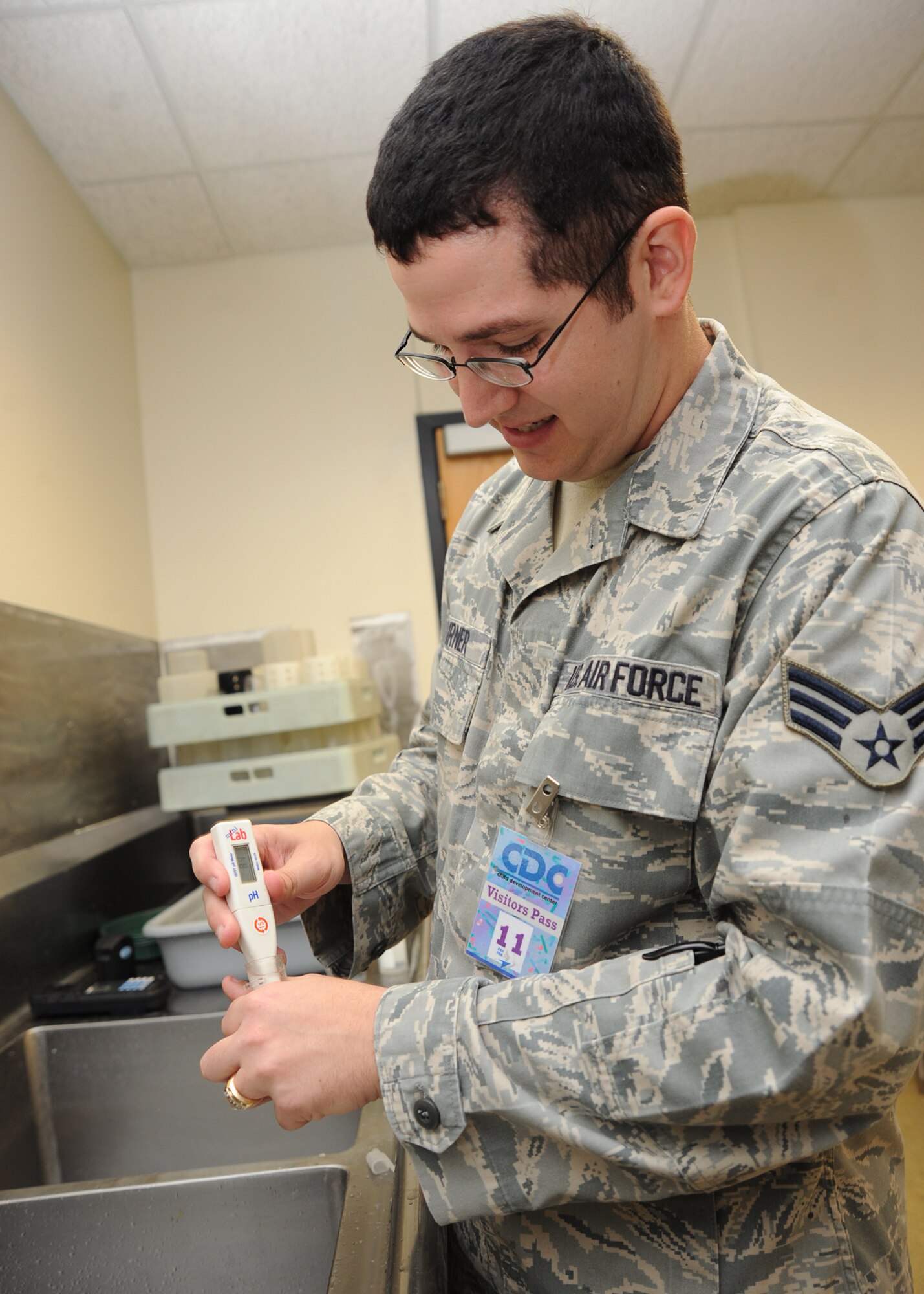 Senior Airman Jon Turner, 22nd Aerospace Medicine Squadron bioenvironmental engineering technician, tests the pH level of faucet water at the Child Development Center June 15, 2010, McConnell Air Force Base, Kan.  Bioenvironmental engineering Airmen do monthly tests on McConnell’s water distribution system at random locations to calculate the amount of pH, chlorine and fluoride in the water.  Water samples are given to the state to assure that chlorine levels are at a minimal level of one milligram per liter proper disinfection of drinkable water.  The bioenvironmental engineer Airmen use environmental sampling equipment to collect drinking water, wastewater, air, soil and other environmental samples for physical, chemical, radiological and bacteriological analysis. (U.S. Air Force photo/ Senior Airman Maria Ruiz).
