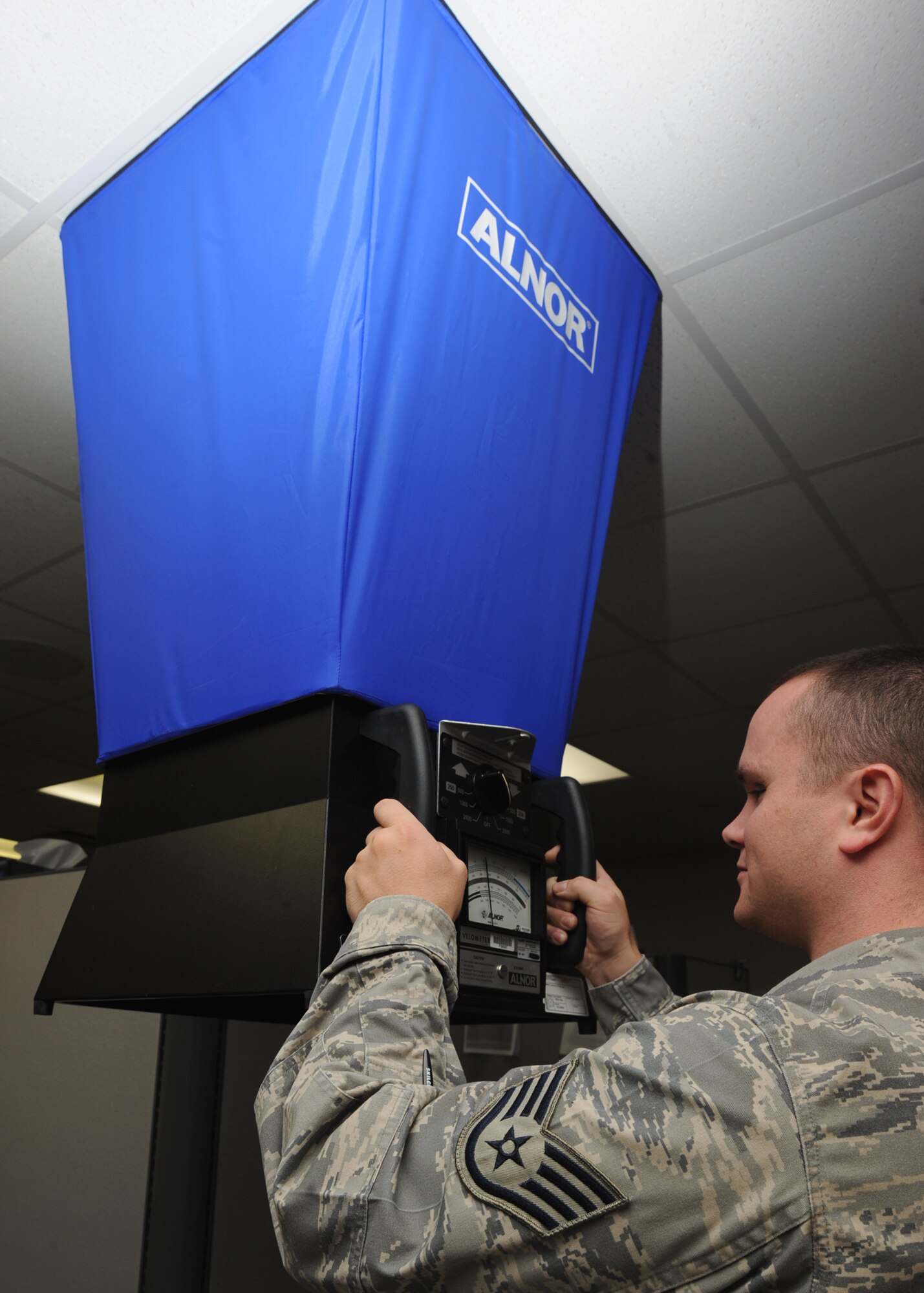 Staff Sgt. Cody LeNeve, 22nd Aerospace Medicine Squadron bioenvironmental engineering apprentice, uses a balometer to measure the ventilation air flow inside a room at the base clinic June 3, 2010, McConnell Air Force Base, Kan.  The balometer measures the amount of air supplied to a room, air flow from a supply and exhaust vent and the air changes per hour in a room.  These measurements will help engineers determine if the appropriate air flow in a building is available. (U.S. Air Force photo/ Senior Airman Maria Ruiz)
