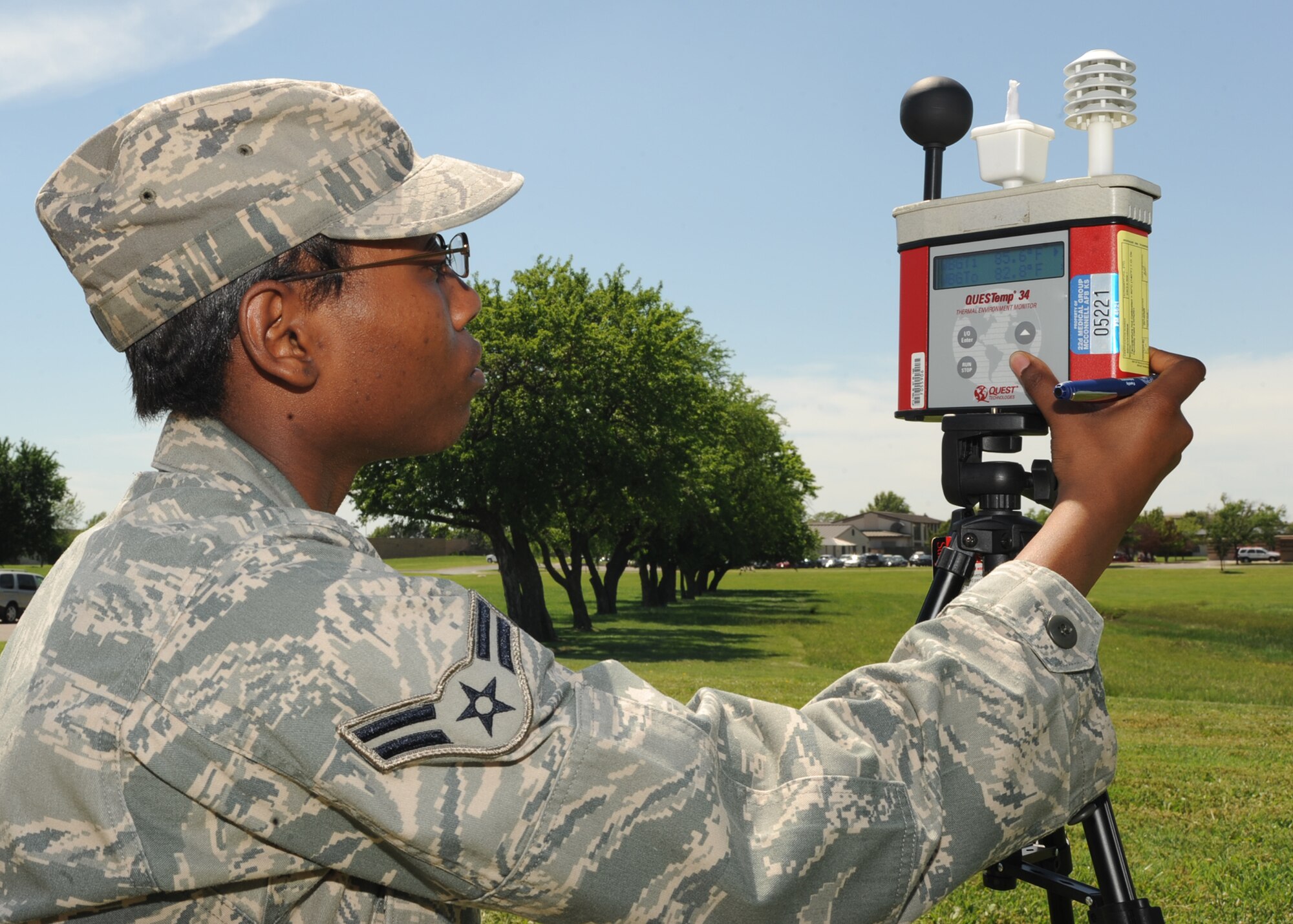 Airman 1st Class Chaveette Hillard, 22nd Aerospace Medicine Squadron bioenvironmental engineering apprentice, adjusts the settings on a wet bulb globe temperature meter outside the base clinic June 3, 2010, McConnell Air Force Base, Kan.  Bioenvironmental engineering Airmen read these findings every hour during normal working hours, seven days a week, once the ambient temperature has reached 85 degrees.  The meter measures wind speed, normal air temperature, solar radiation and humidity to accurately calculate the ambient temperature.  These readings help safety representatives determine the work rest cycles, fluid replacement guideline and base heat categories. (U.S. Air Force photo/ Senior Airman Maria Ruiz)