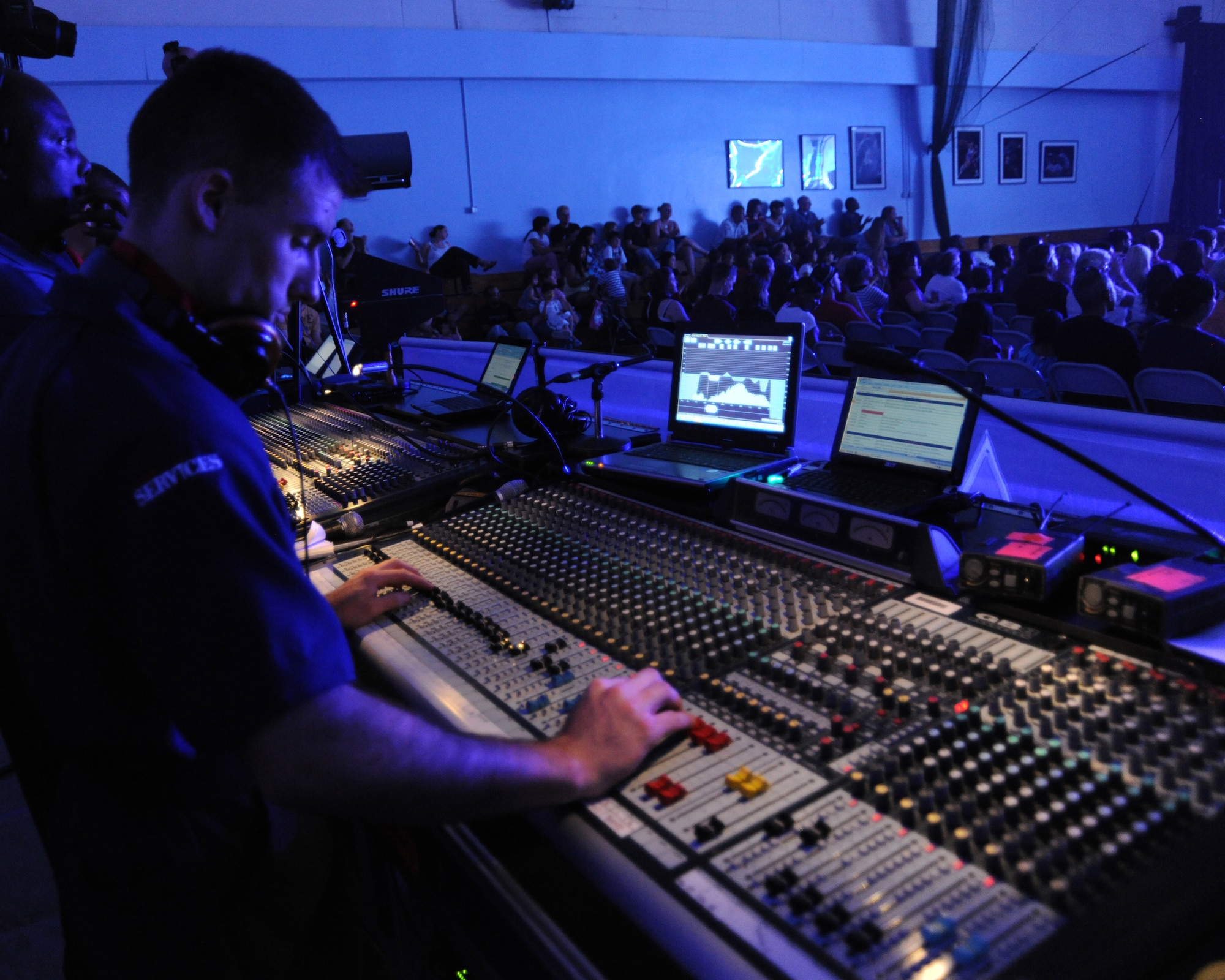 RAF CROUGHTON, United Kingdom - Airman 1st Class William Anger works the audio equipment during a Tops In Blue peformance June 22 here. Airman Anger is assigned to the 736th Aircraft Maintenance Squadron at Dover Air Force Base, Del.(U.S. Air Force photo by Staff Sgt. Joel Mease)