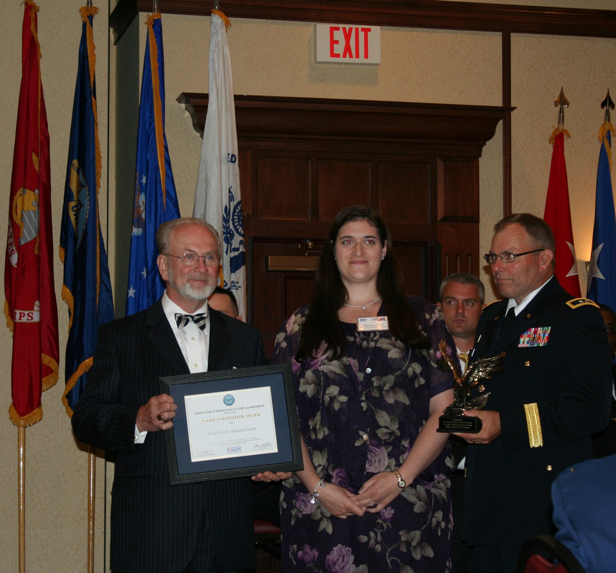 WRIGHT-PATTERSON AIR FORCE BASE, Ohio - Mr. John Hopper, State Chairman, Ohio Committee for the Employer Support of the Guard and Reserve and Maj. Gen. Matthew Kambic, Assistant Adjutant General of the Army, Joint Forces Ohio, Ohio Army National Guard, present the Above and Beyond Award to Allison Pond, Pond Family Medical Center at the Ohio Committee for ESGR Annual Employer Recognition Dinner June 5.  Ms. Pond and her husband, Maj. David Pond, 89th Airlift Squadron, owners of Pond Family Medical Center, were recognized for their support of reserve employees. (U.S. Air Force photo/Maj. Cynthia Harris)