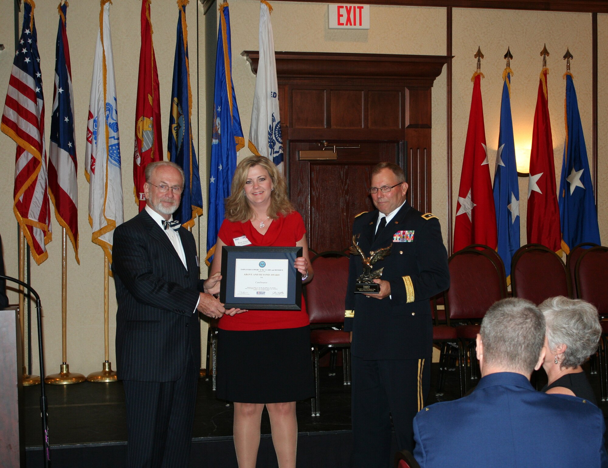 WRIGHT-PATTERSON AIR FORCE BASE, Ohio - Mr. John Hopper, State Chairman, Ohio Committee for the Employer Support of the Guard and Reserve and Maj. Gen. Matthew Kambic, Assistant Adjutant General of the Army, Joint Forces Ohio, Ohio Army National Guard, present the Above and Beyond Award to Kim Gibson of CareSource at the Ohio Committee for ESGR Annual Employer Recognition Dinner June 5. CareSource is the employer of Staff Sgt. Patrick Smith, 87th Aerial Port Squadron. (U.S. Air Force photo/Maj. Cynthia Harris)