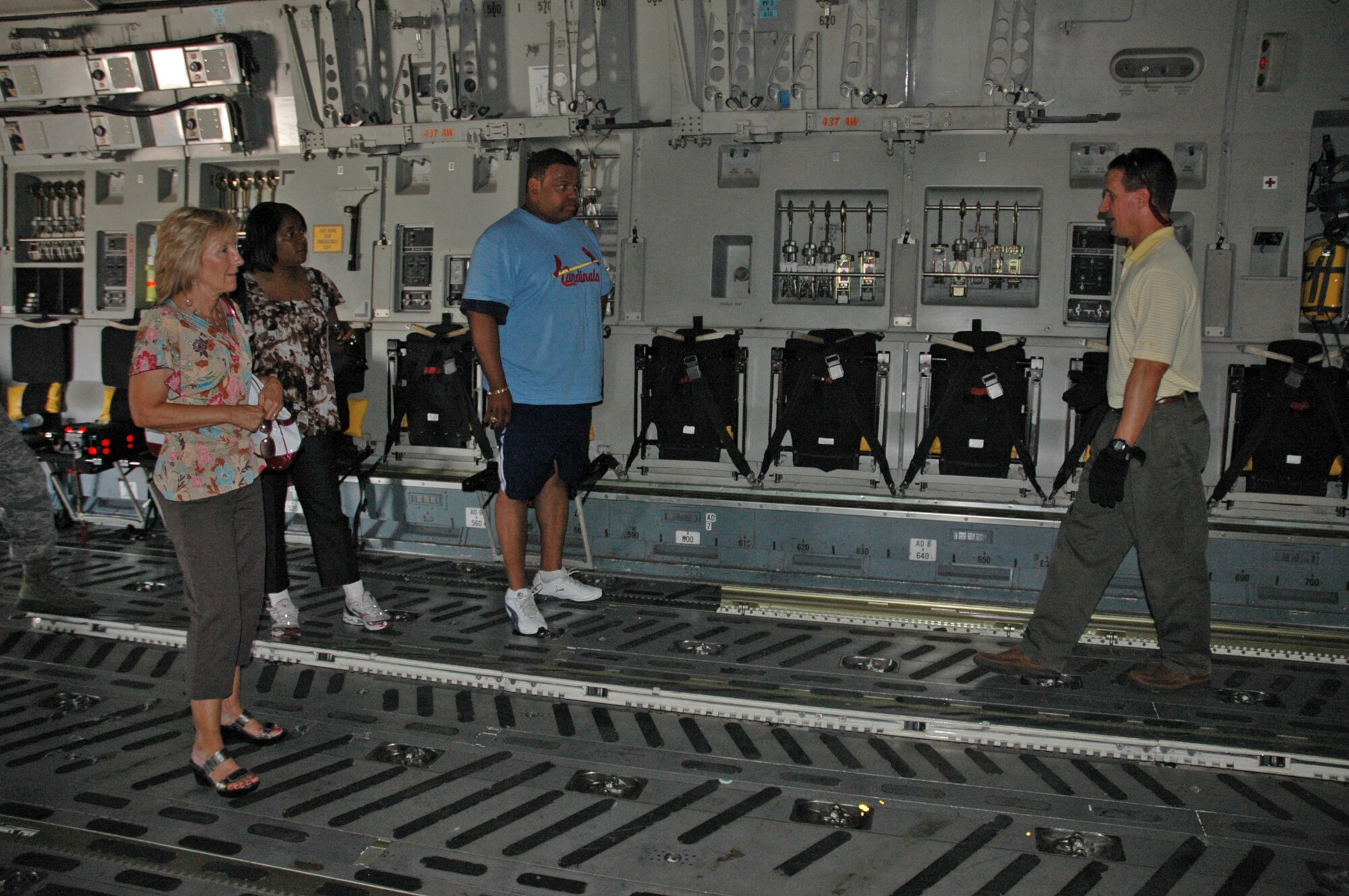 Ken Hundermer, loadmaster with the 317th Airlift Squadron, Charleston Air Force Base S.C. and manager of the Denton Humanitarian Assistance Program here, leads members from U.S. Transcom and the U.S. Defense Security Cooperation Agency on a tour of a C-17 June 23. The visitors were able to see a C-17 and the Aerial Port squadron on thier visit to gain a better understanding of the Denton program. (U.S. Air Force Photo/2nd Lt Joe Simms)