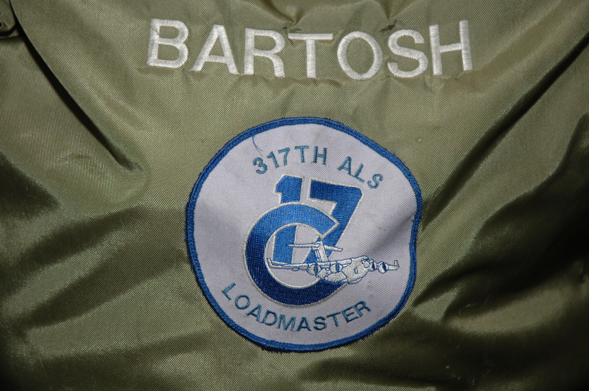 Helmet bag of Master Sgt. Johnny Bartosh, C-17 examiner loadmaster with the 315th Airlift Wing at Charleston air Force Base, S.C., and the original C-17 patch issued to him by McDonnell Douglas when he began working on the aircraft. (U.S. Air Force photo/Staff Sgt. Shane Ellis)