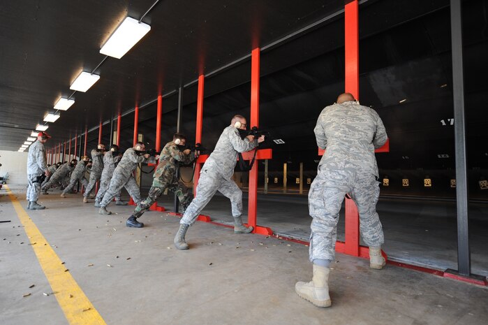 Members of the 628th Security Forces Squadron fire  M-4 rifles on the improved range on Joint Base Charleston, S.C., June 21, 2010. Firing ammo rounds on the range is part of the certification process to ensure no rounds are exiting or ricochet from the range. Various weapons can be fired on the range, to include the M-9, M-16, shotguns and the M-11. (U.S. Air Force photo/James M. Bowman)(released)