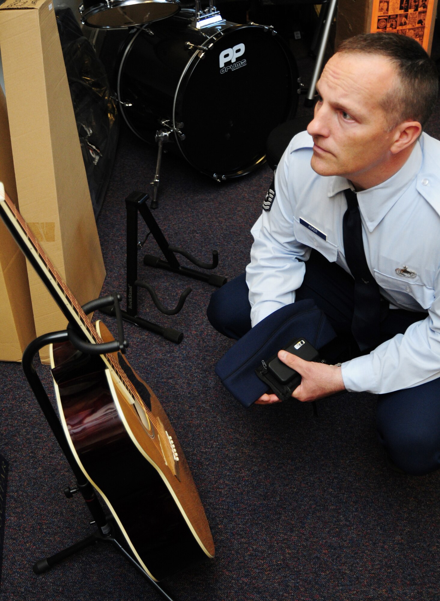 Master Sgt. Stephen Acker, 48th Operations Group Intelligence NCO in-charge of intelligence analysis, looks at a guitar at the Outdoor Recreation music store on RAF Lakenheath June 21. The selection of instruments includes guitars (electric, classic and acoustic) saxophones, flutes, violins, organs, drum kits and more.  Accessories include strings, leads, drumsticks, music stands guitar straps drum skins, picks etc., with a large selection of amplifiers on hand. (U.S. Air Force photo/Airman 1st Class Lausanne Morgan)