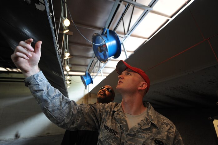 Staff Sgt. Jason Whisenhunt and Darnell Edmonds inspect the baffles of the improved weapons firing range on Joint Base Charleston, S.C., June 21, 2010. The improved range has 30 fans that blow gun smoke down and out the range, making it well ventilated so instructors and students don't inhale the smoke. Mr. Edmonds is the 628th Air Base Wing deputy ground safety manager and Sergeant Whisenhunt is a combat arms instructor with the 628th Security Forces Squadron. (U.S. Air Force photo/James M. Bowman)(released)