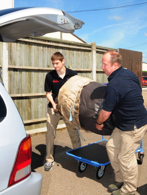 Rob Francis, 48th Force Support Squadron Outdoor Recreation aide, and lead recreation aide George Rathbun prepare to load an air castle into a van for a customer on RAF Lakenheath June 21. Utility trailers are also available for transporting larger equipment not able to fit in smaller vehicles. (U.S. Air Force photo/Airman 1st Class Lausanne Morgan)