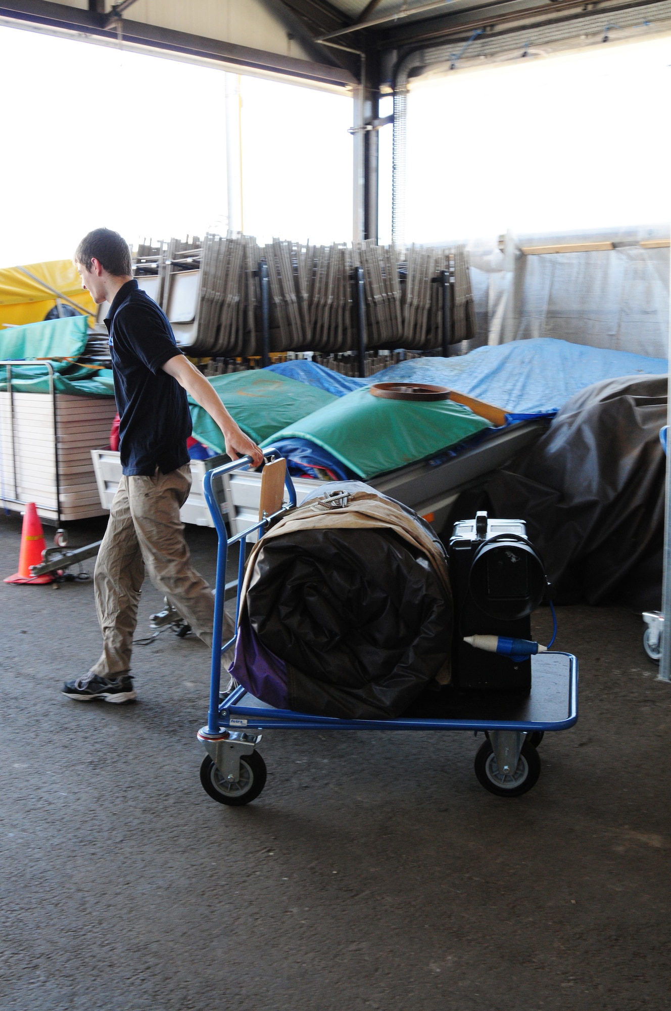 Rob Francis, 48th Force Support Squadron Outdoor Recreation aide, rolls out an air castle for a customer at RAF Lakenheath June 21. Rental prices vary by day, weekend and in some cases, for the whole week. A complete list of equipment prices are available at Outdoor Rec. (U.S. Air Force photo/Airman 1st Class Lausanne Morgan)