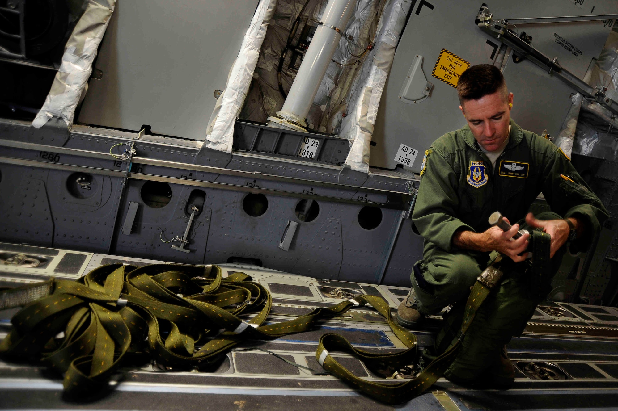 Master Sgt. Johnny Bartosh, C-17 examiner loadmaster with the 315th Airlift Wing at Charleston air Force Base, S.C., rigs a 15 foot drogue chute to a heavy equipment platform in preparation for an airdrop mission. (U.S. Air Force Photo/Tech. Sgt. Dennis J. Henry Jr.)