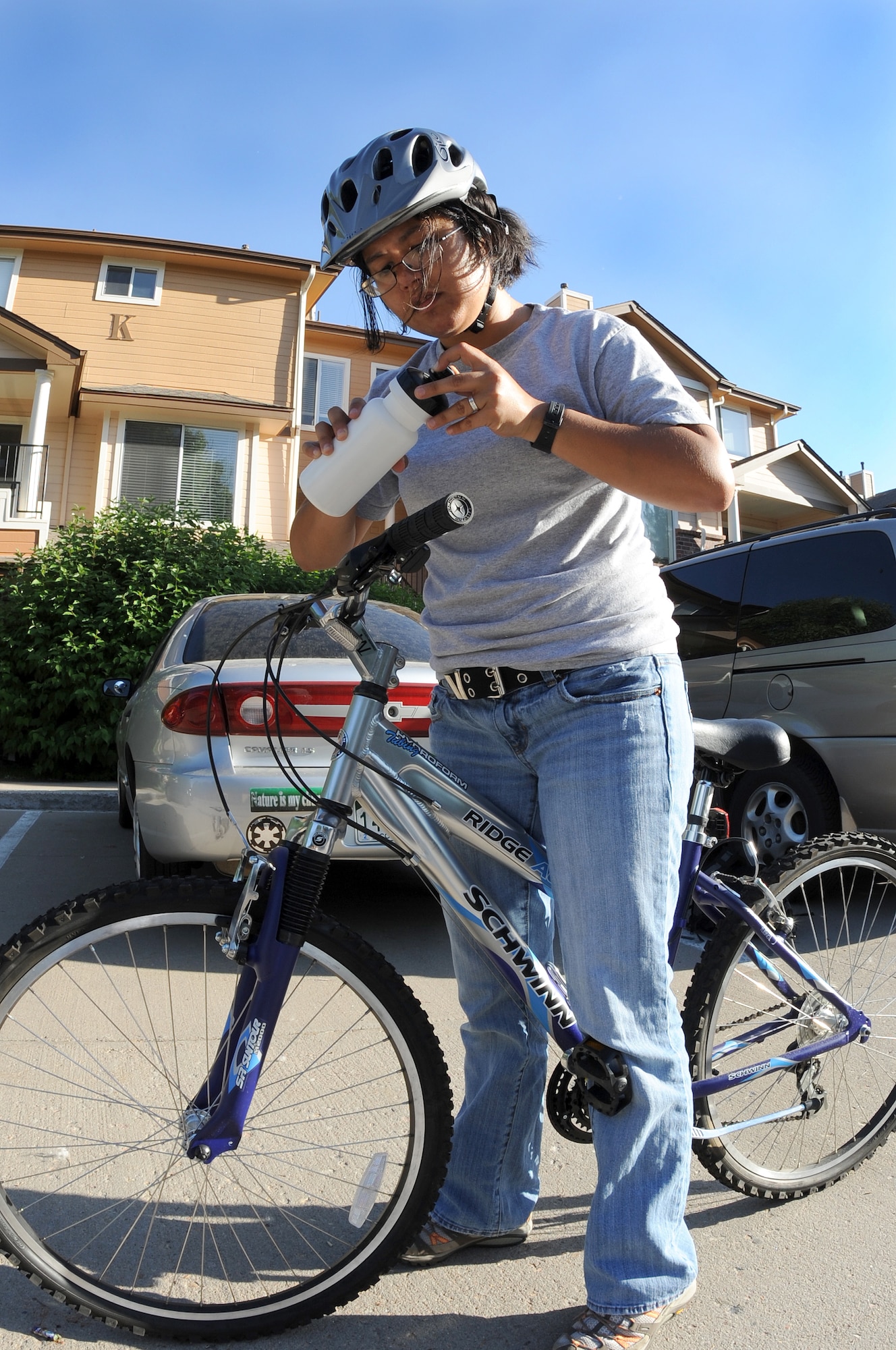 DENVER, Colo. -- Staff Sgt. Kathrine McDowell takes a break to hydrate when riding her bicycle, June 22. One very important safety tip to follow is to keep water with you and stay hydrated. (U.S. Air Force Photo by Airman 1st Class Manisha Vasquez) 