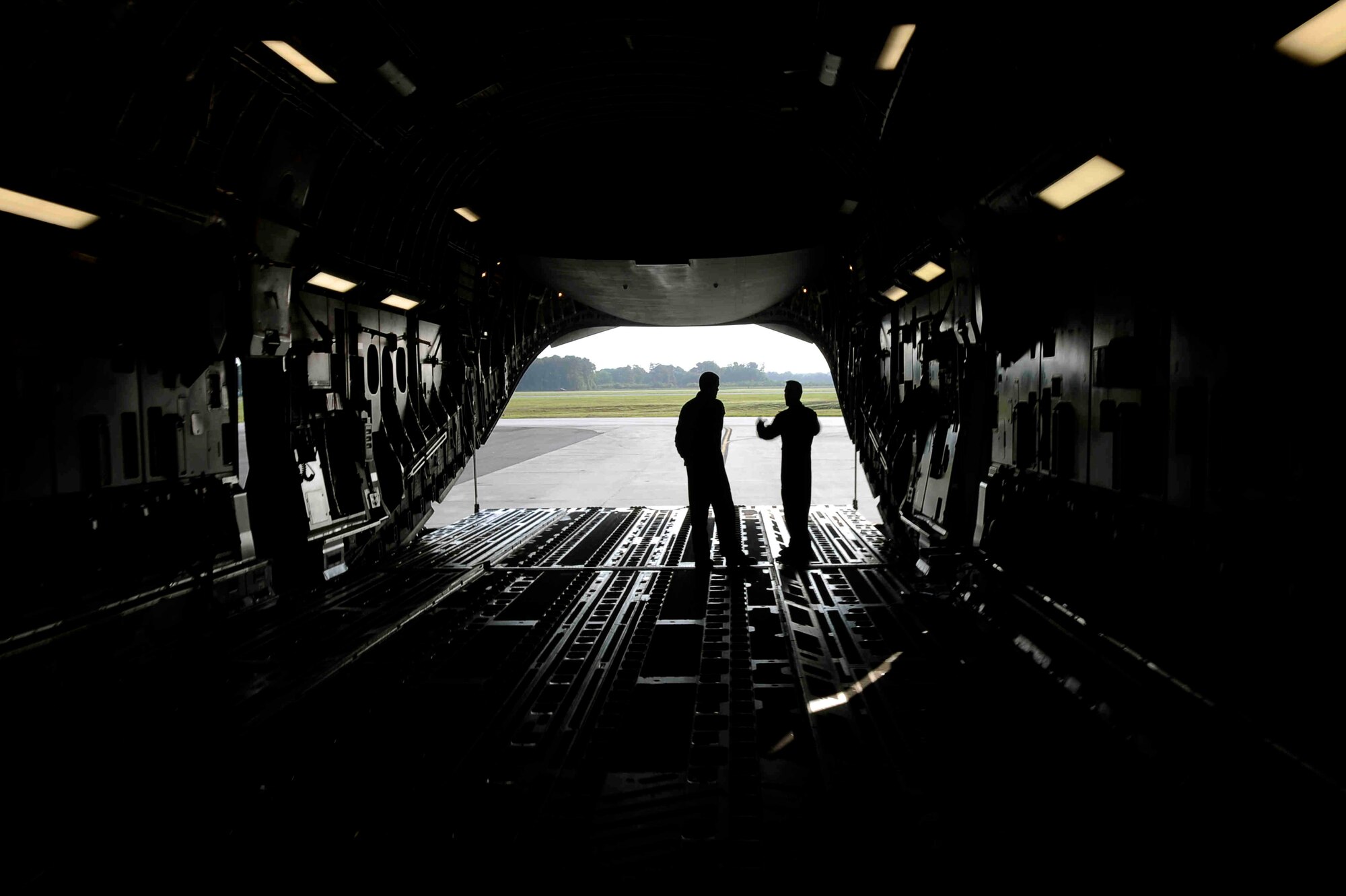 Master Sgt. Johnny Bartosh, C-17 examiner loadmaster with the 315th Airlift Wing at Charleston air Force Base, S.C., talks about the C-17 airdrop system to Master Sgt. Drew Cheek, a loadmaster with the 315 AW at CAFB. (U.S. Air Force Photo/Tech. Sgt. Dennis J. Henry Jr.)