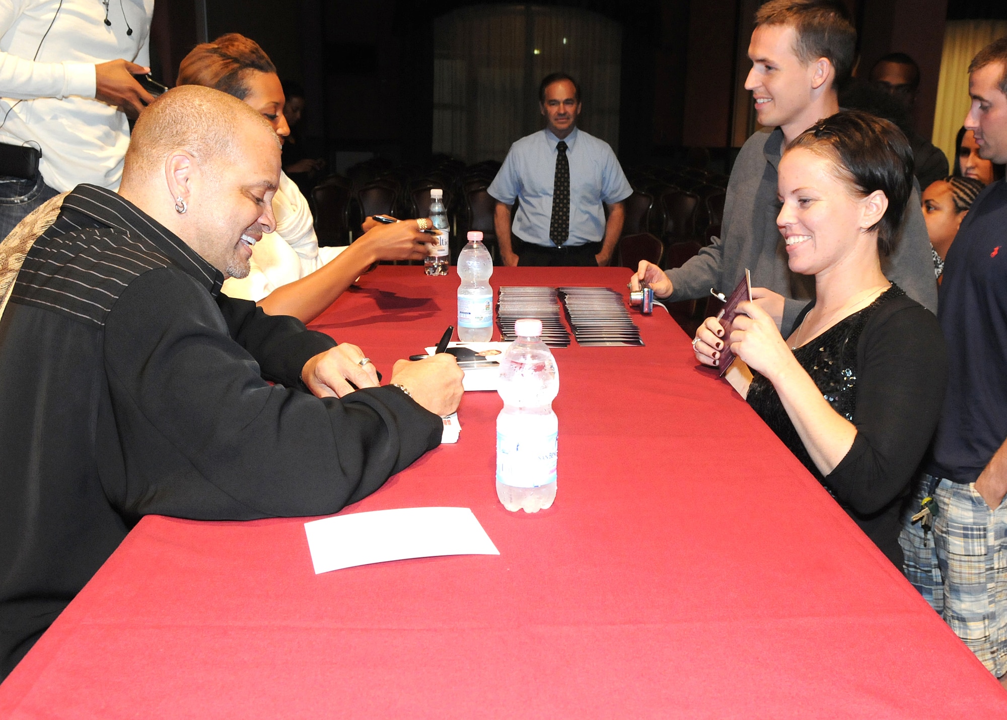 Actor and comedian Sinbad signs an autograph for Staff Sgt. Sara Handley, 31st Comptroller Squadron budget analysis, June 22 at the La Bella Vista Club.  This is part of a 15-day Armed Forces Entertainment tour.  (U.S. Air Force photo/ Staff Sgt. MercedesKimble L. Crossland)