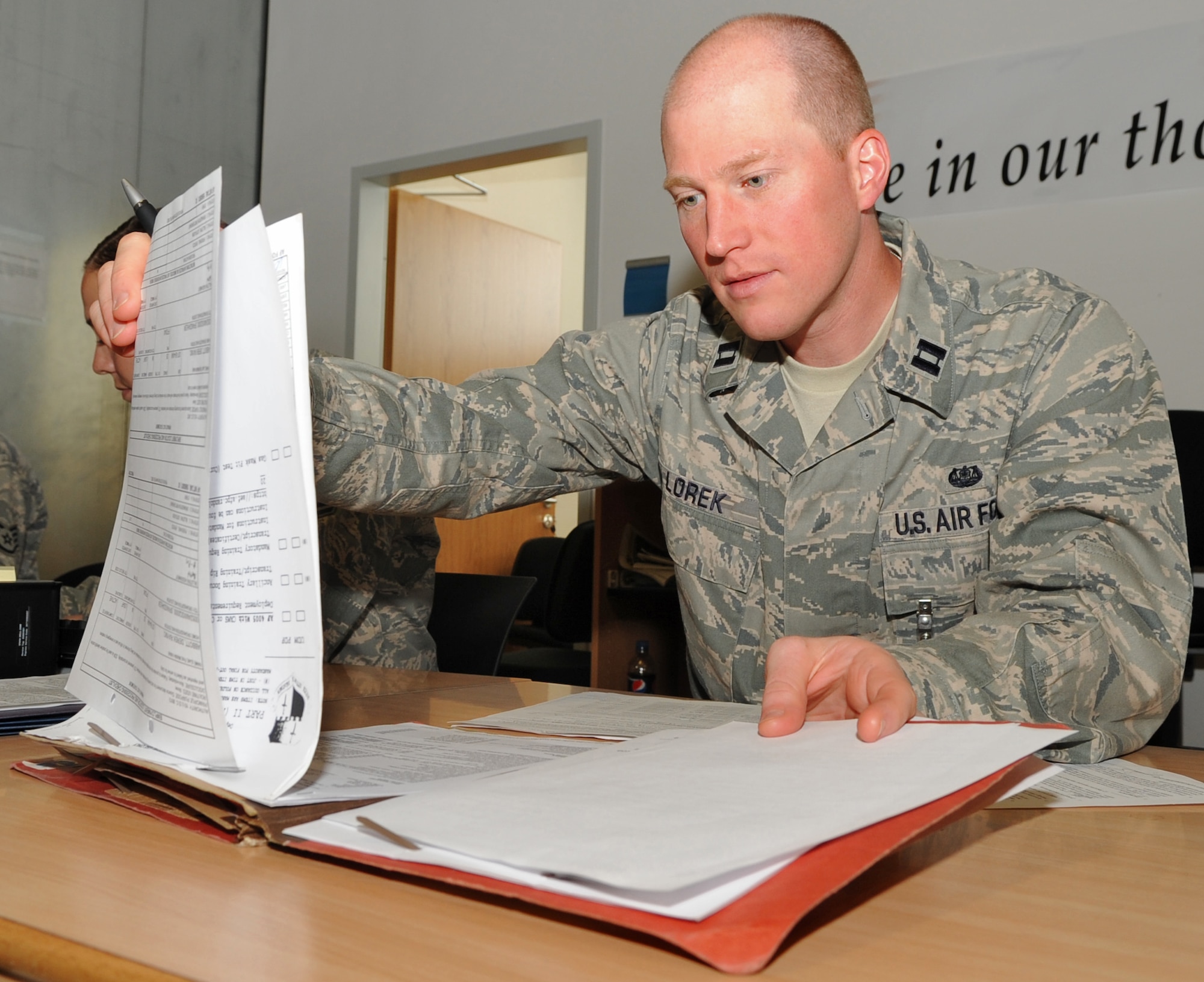 SPANGDAHLEM AIR BASE, Germany – Capt. Jeff Lorek, 52nd Fighter Wing Judge Advocate, chief of operations law, certifies Law of Armed Conflict training compliance for an Airman processing through the personnel deployment function during a Phase I Operational Readiness Inspection June 21. The PDF is part of a predeployment checklist Airmen must go through to ensure they have all the proper documentation, medical clearances and requirements to deploy. (U.S. Air Force photo/Airman 1st Class Nick Wilson)