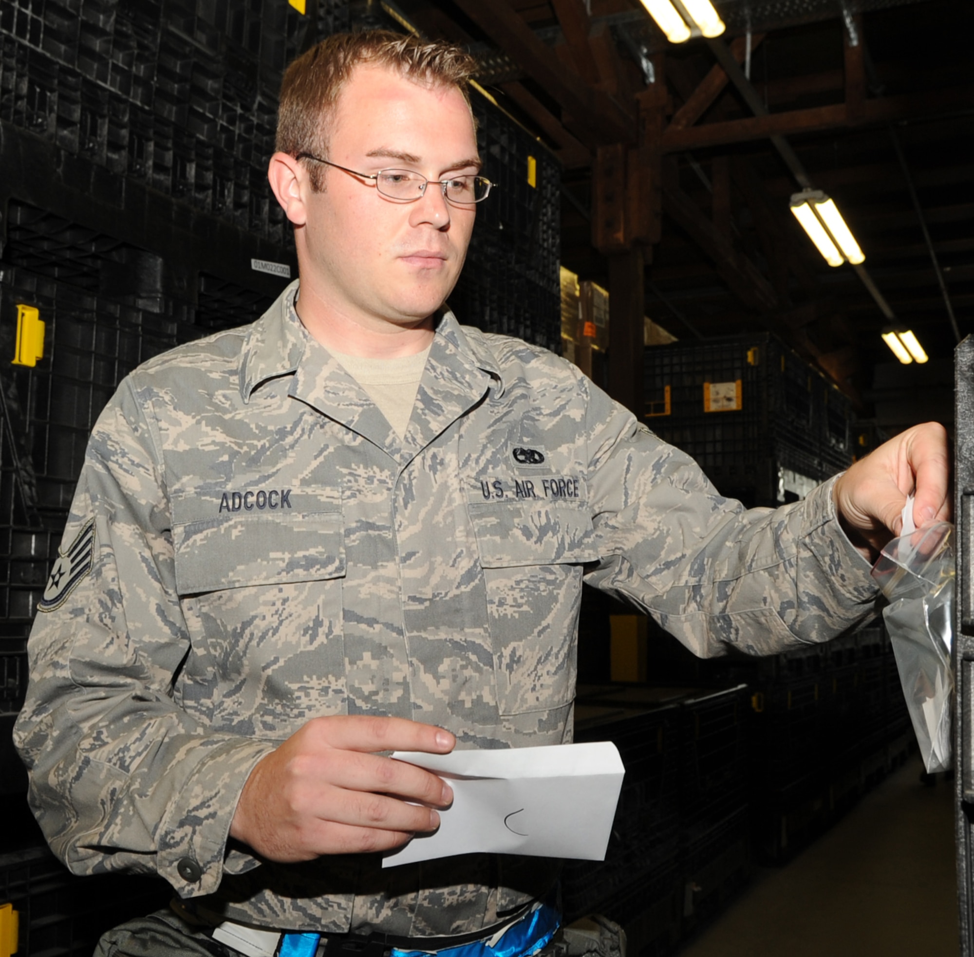 SPANGDAHLEM AIR BASE, Germany – Staff Sgt. Joshua Adcock, 52nd Aircraft Maintenance Squadron F-16 Avionics Craftsman, takes a simulated desert Joint Service Lightweight Integrated Suit Technology coat while going through a mobility processing line during a Phase I Operational Readiness Inspection June 21. The JLIST is part of a suit used to protect against chemical and biological attacks. This was part of the mobility equipment issued to Sergeant Adcock during a simulated personnel deployment function. (U.S. Air Force photo/Airman 1st Class Nick Wilson)